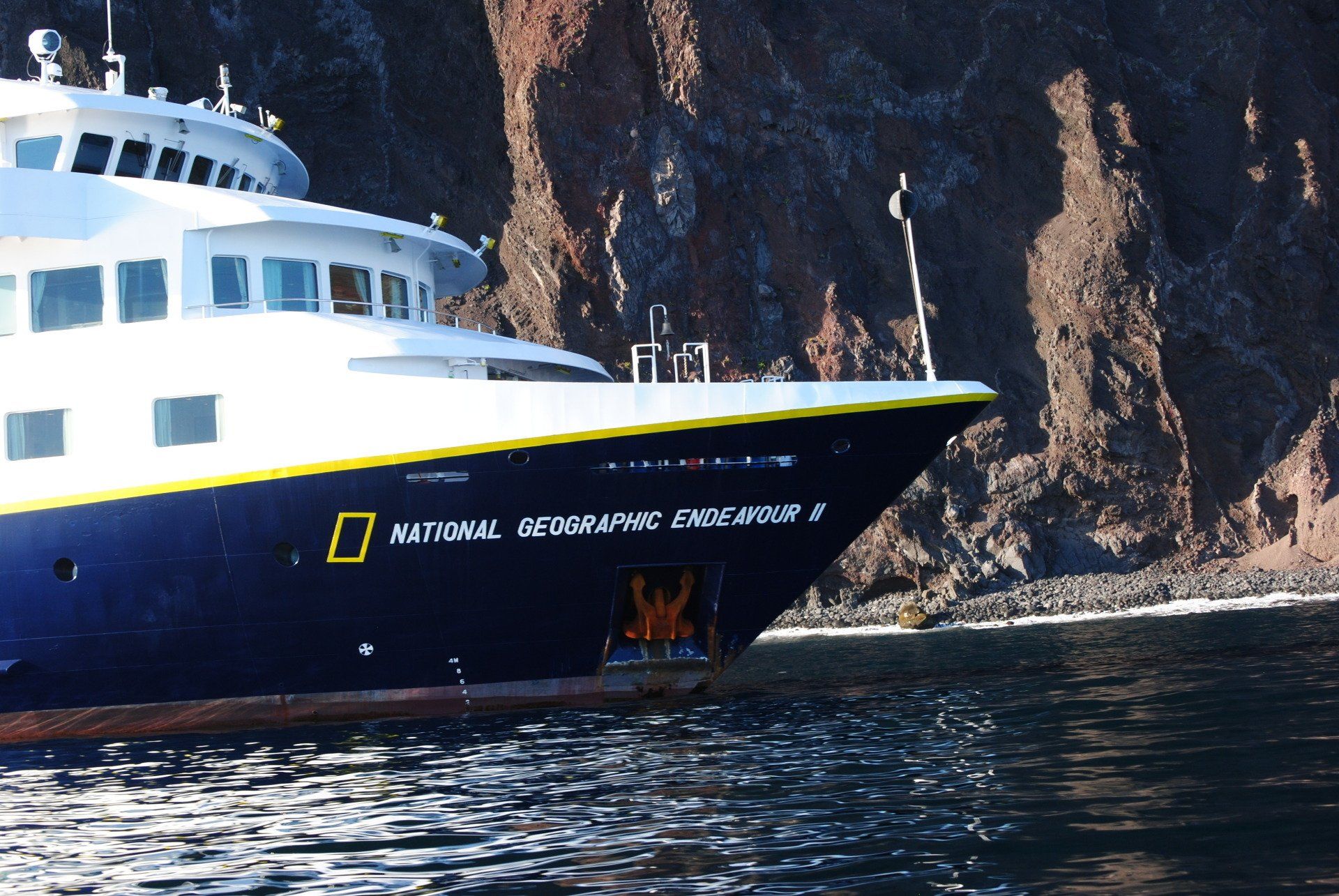 A national geographic ship is floating in the water