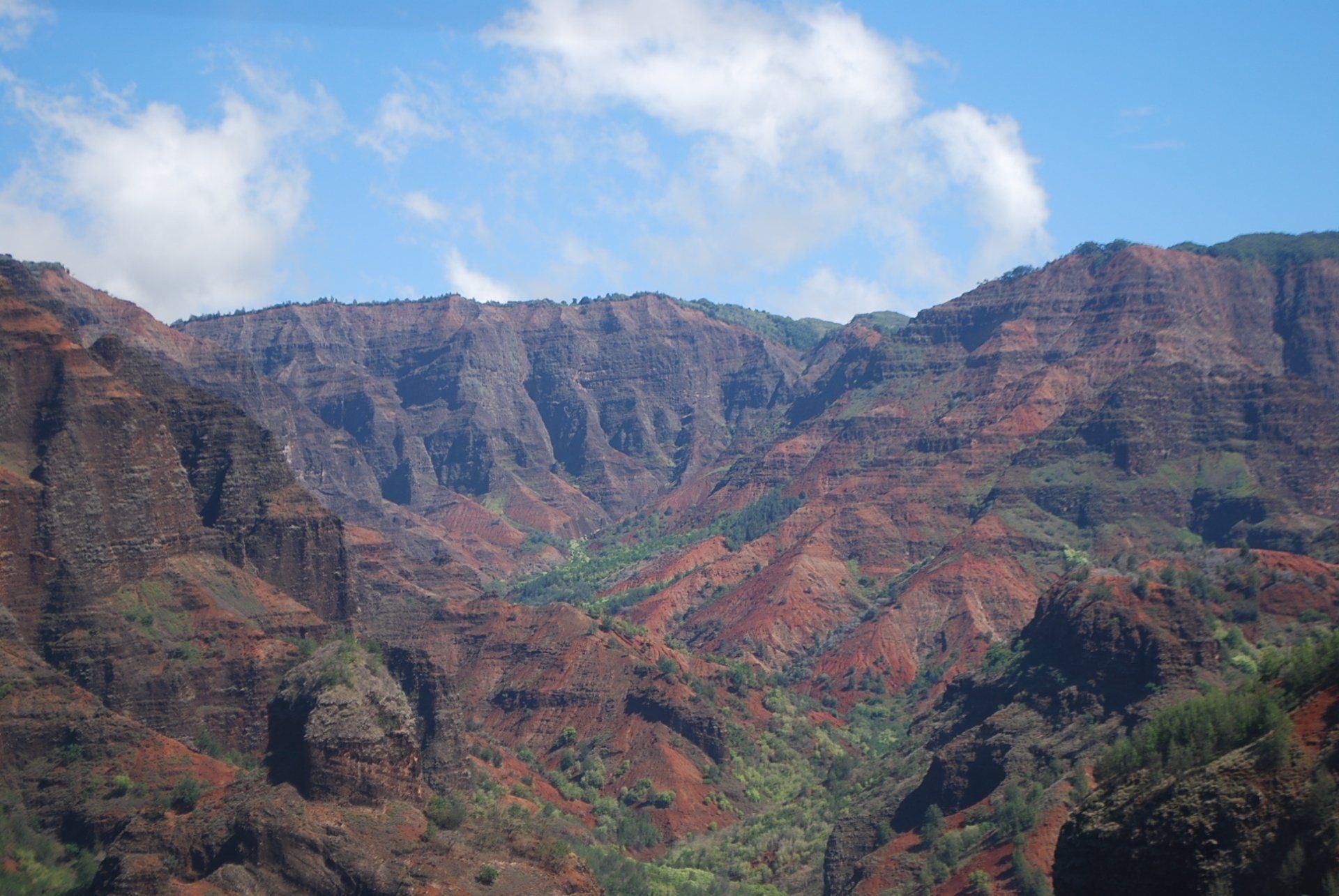 A view of a canyon with mountains in the background