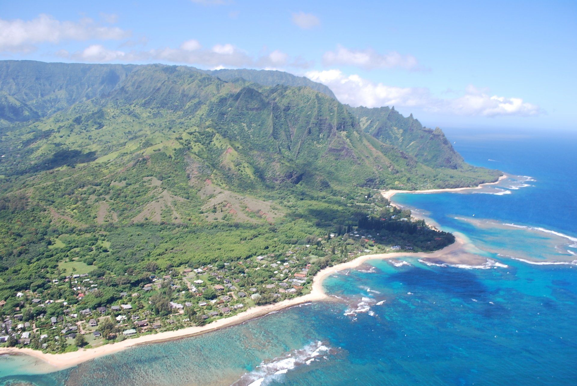 An aerial view of a beach with mountains in the background