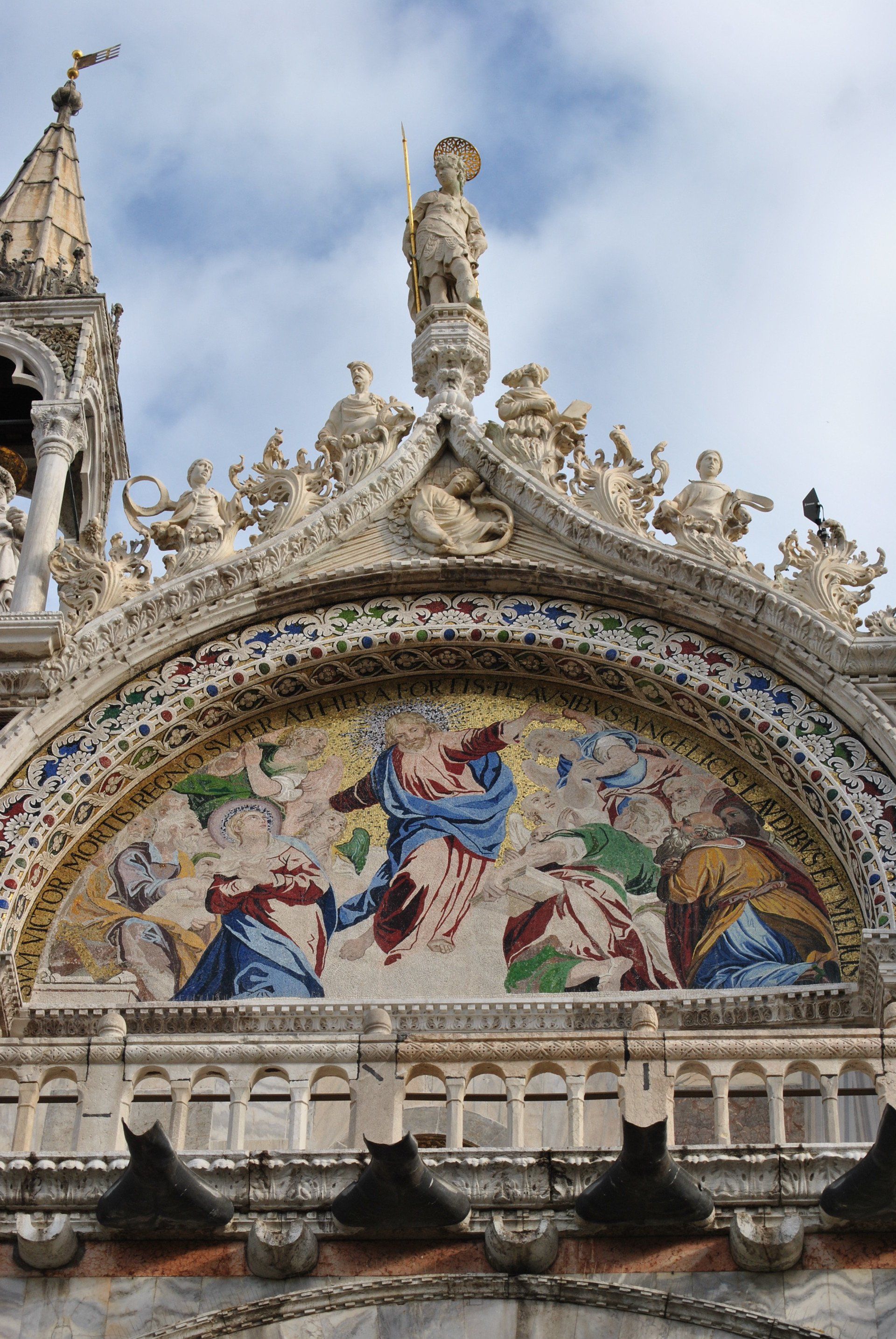 A statue on top of a building with a painting on it