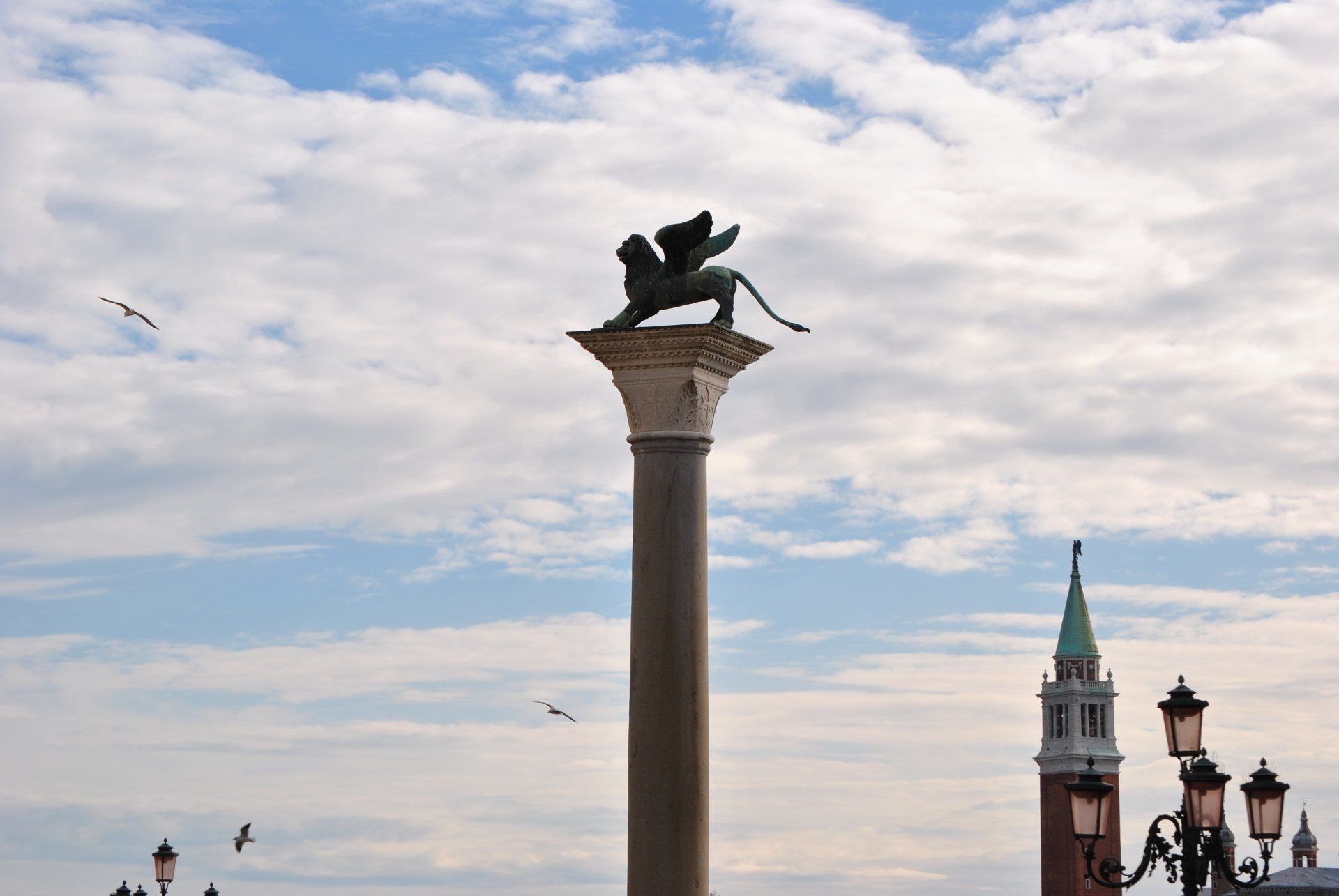 A statue of a lion on top of a stone column