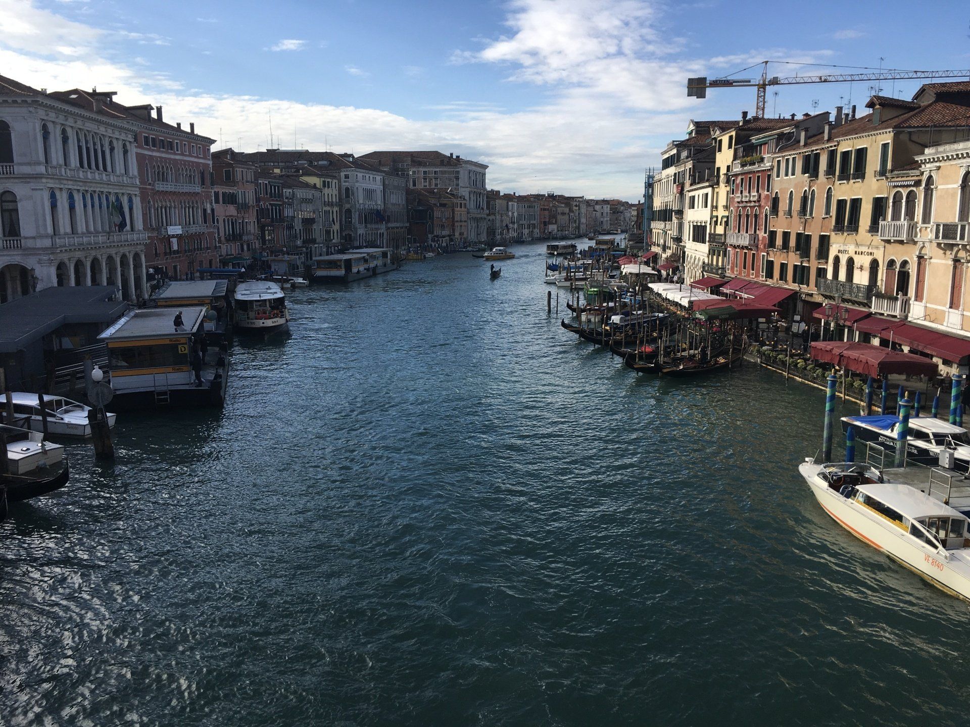 A large body of water surrounded by buildings and boats.