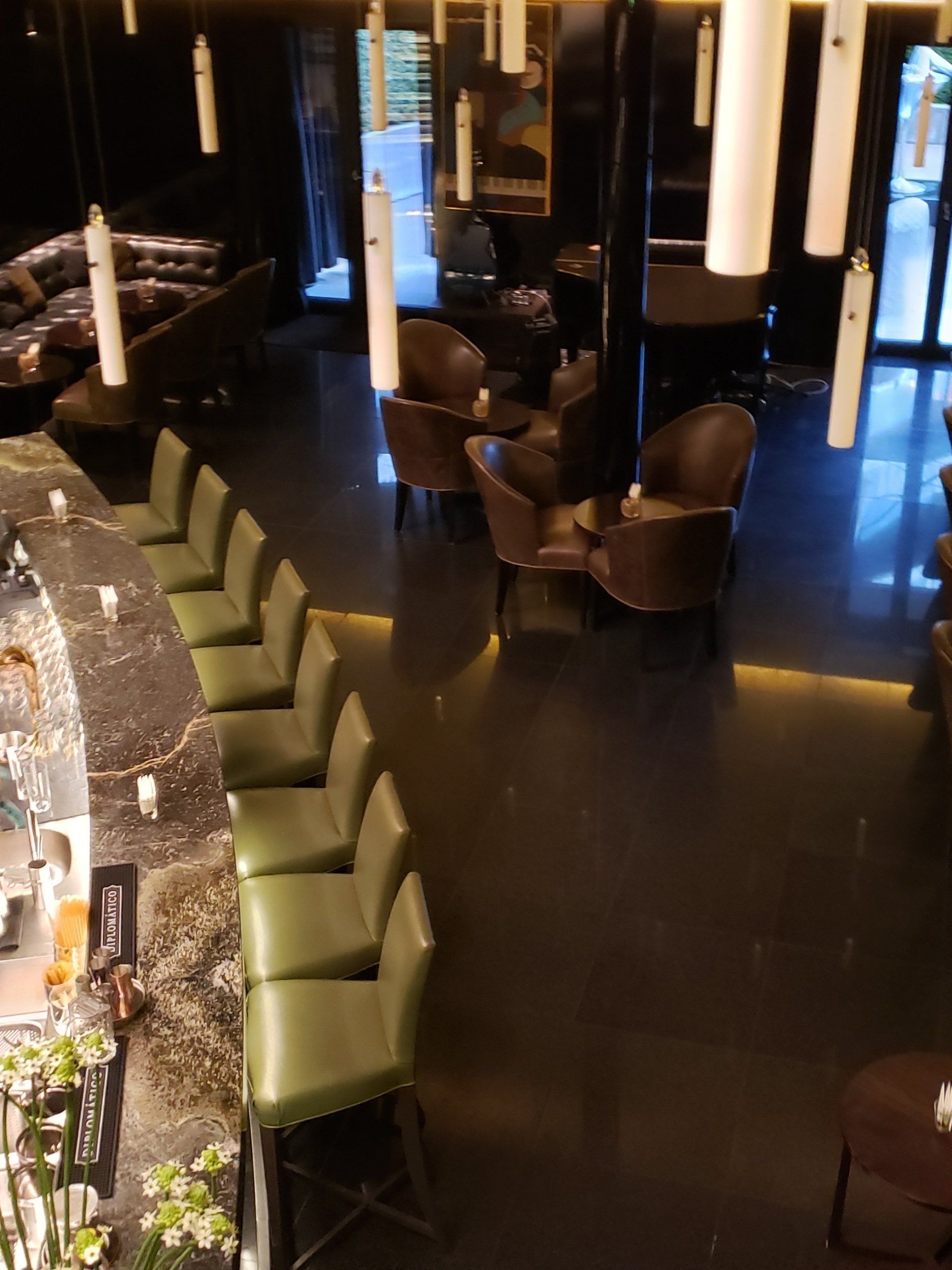 An aerial view of a restaurant with green chairs and tables