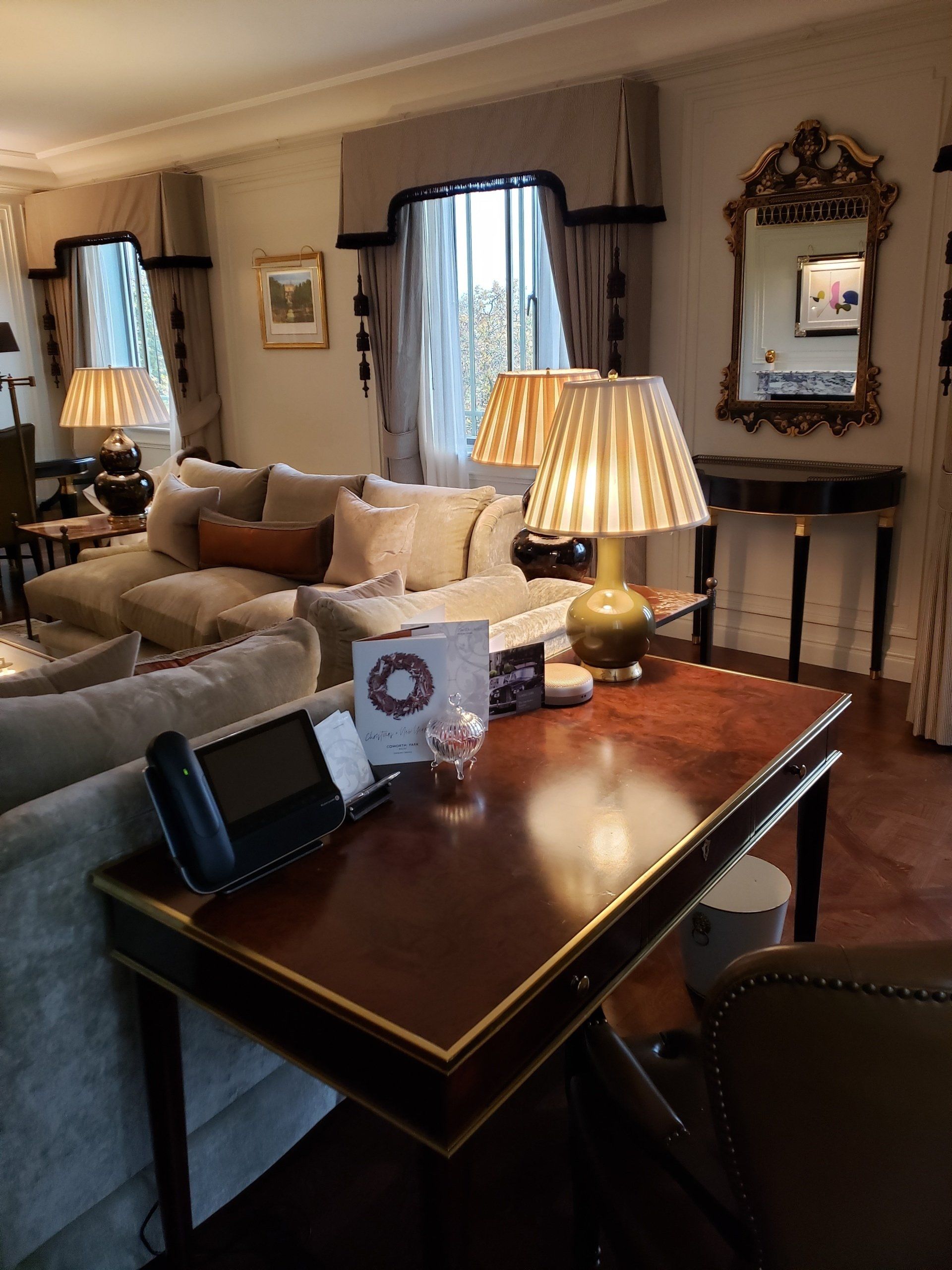 A living room filled with furniture and a desk with a phone on it