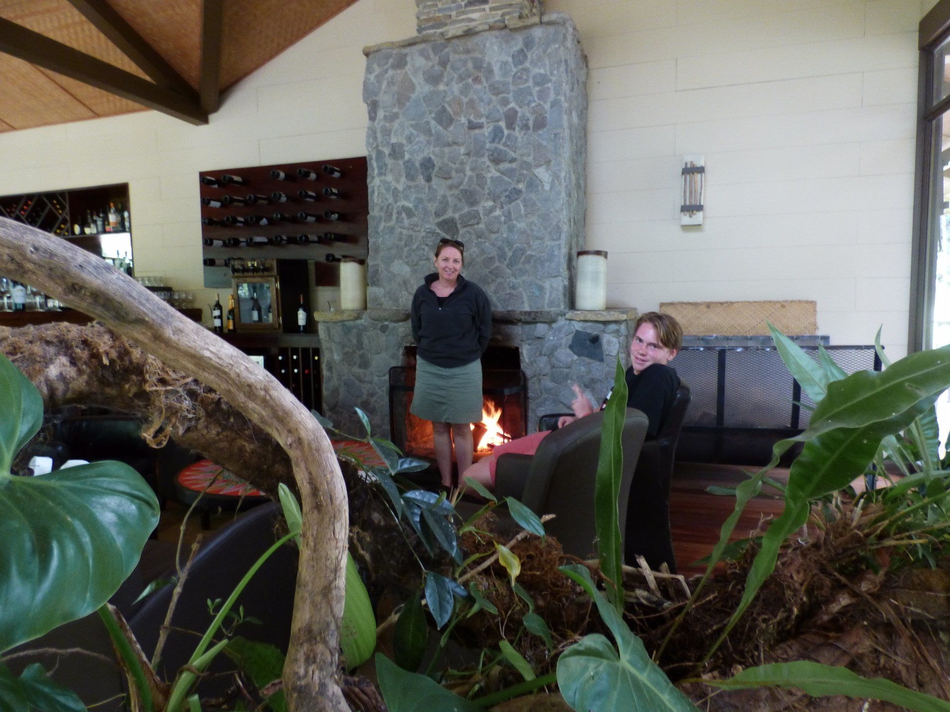 Two women standing in front of a fireplace in a living room