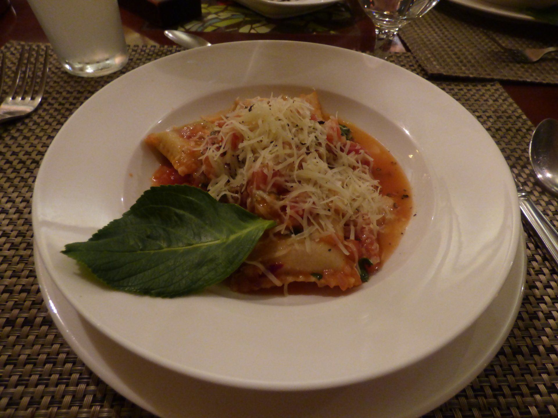 A plate of food with a leaf on it on a table