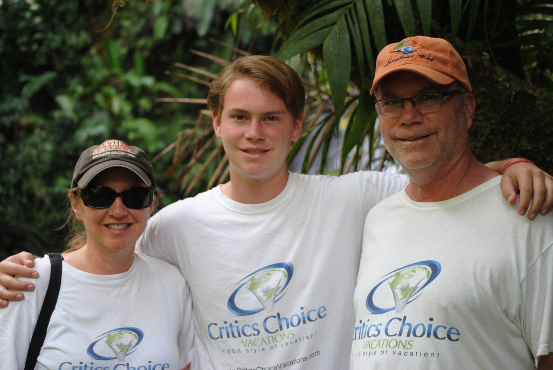 A man and two women wearing critics choice shirts pose for a picture