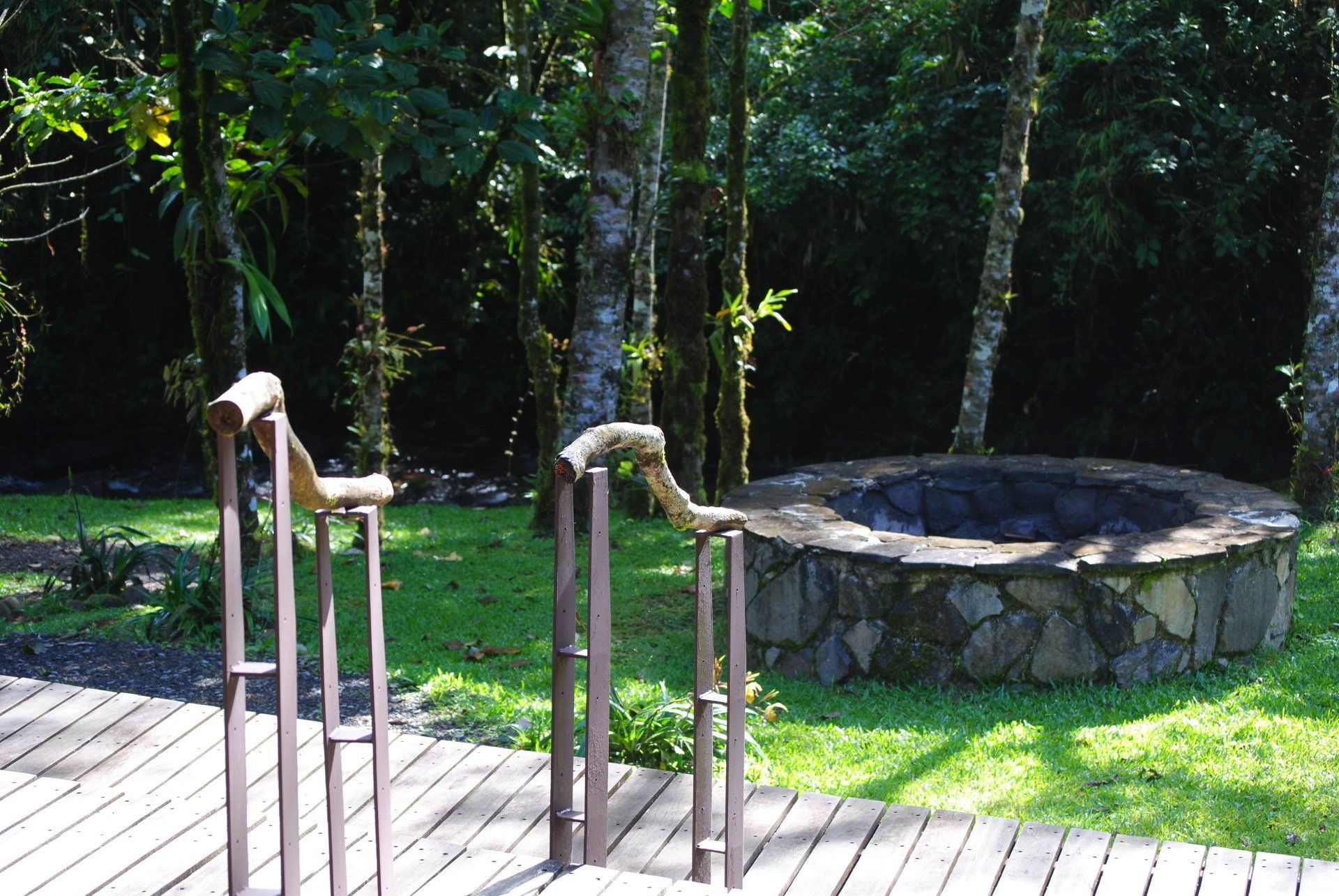 A wooden deck with stairs leading to a fire pit