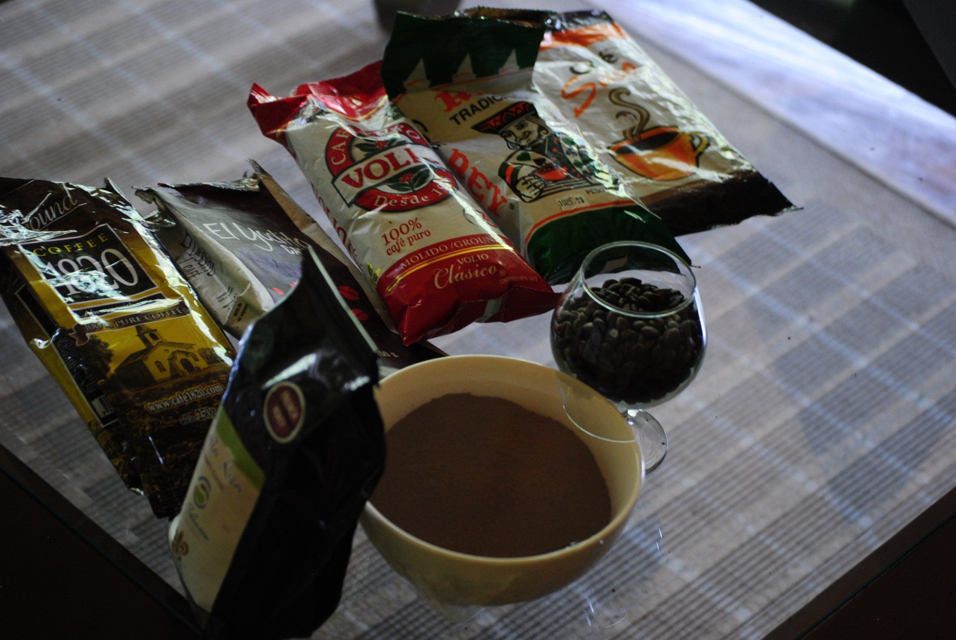 A bowl of chocolate next to a bag of voll