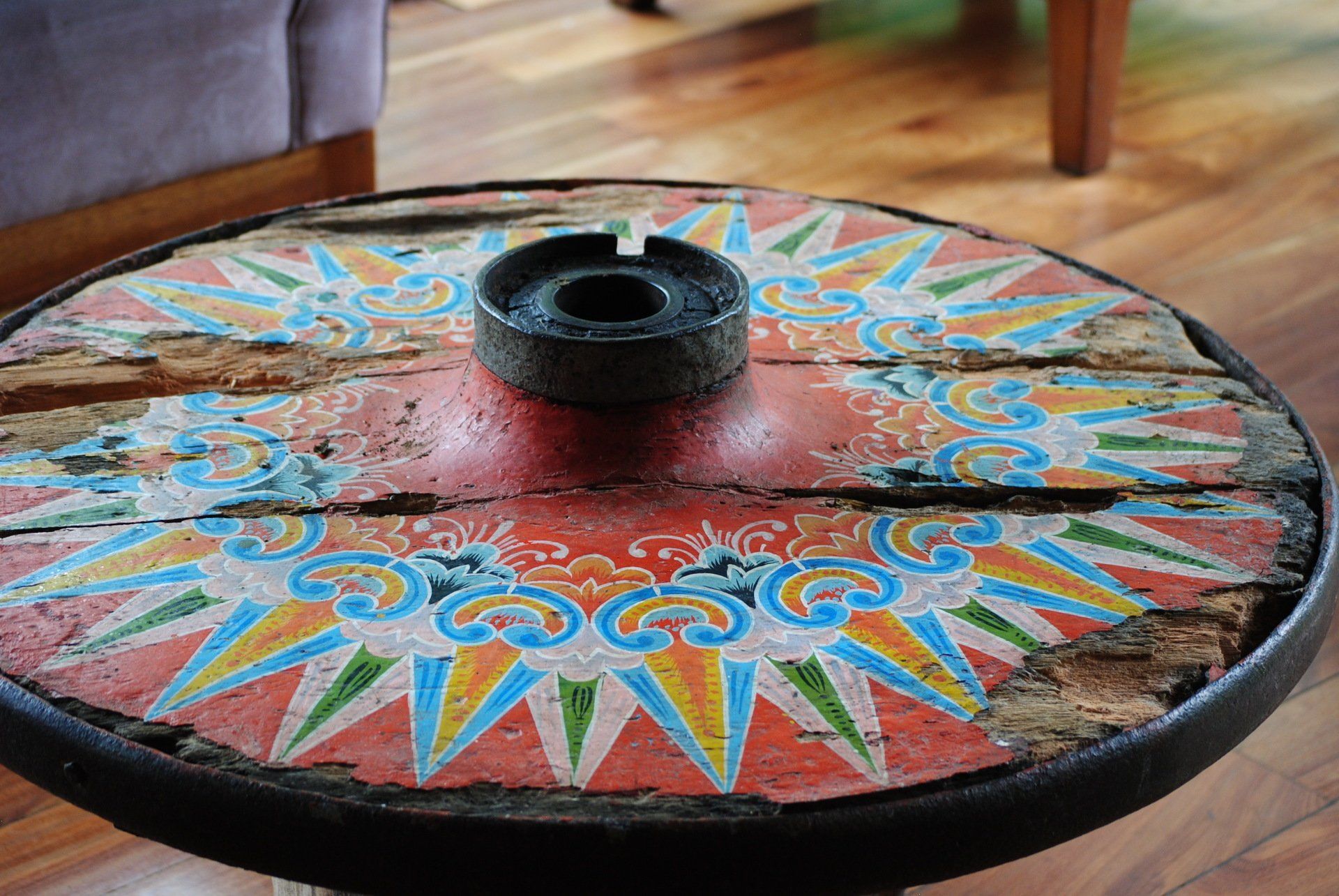 A colorful table with an ashtray on top of it