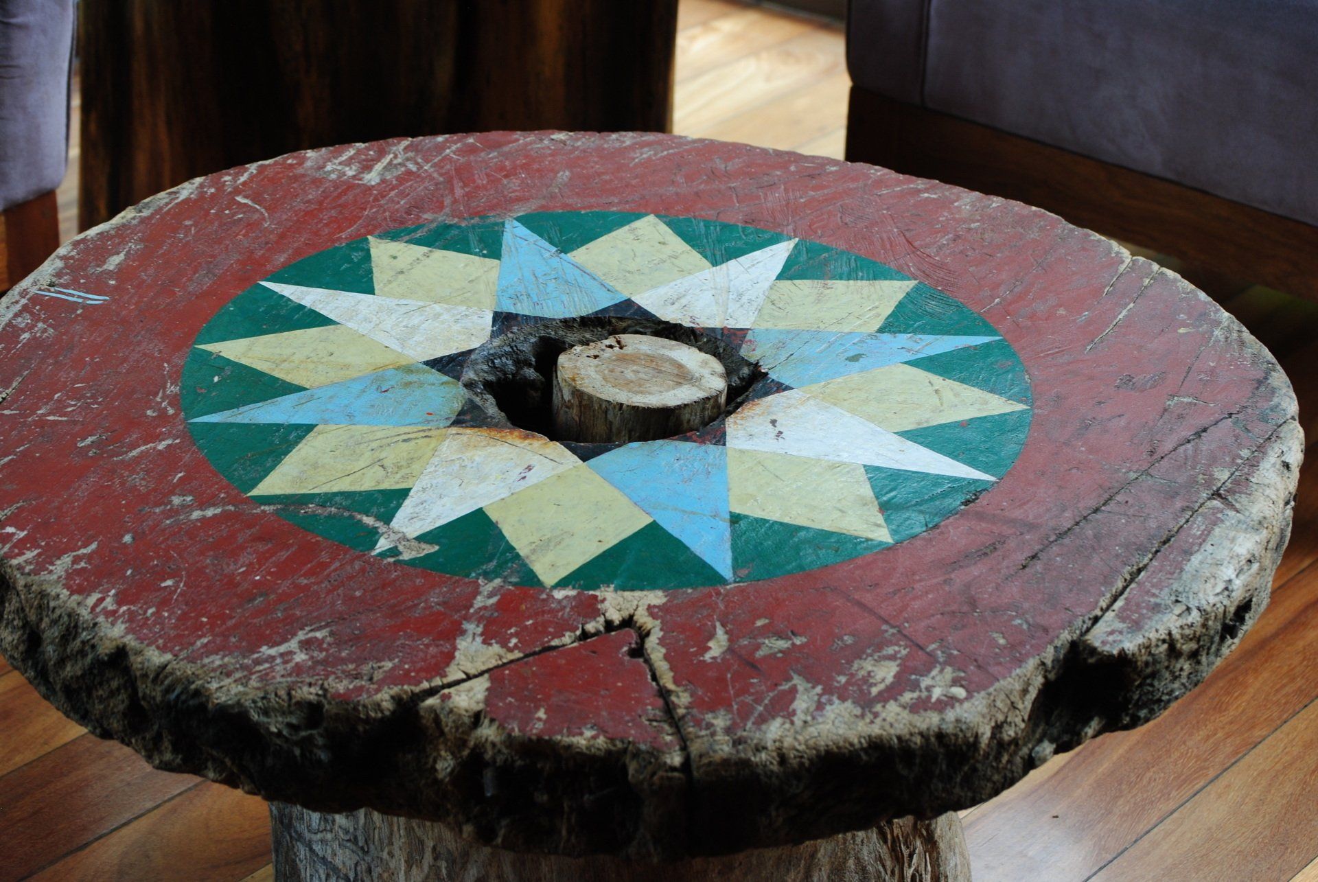 A wooden table with a colorful design on it