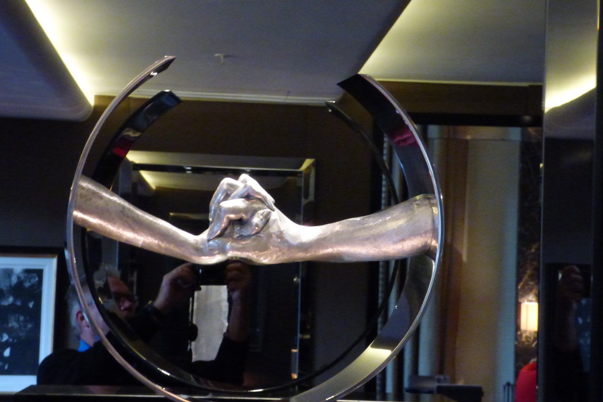 A statue of two hands holding each other in a circle