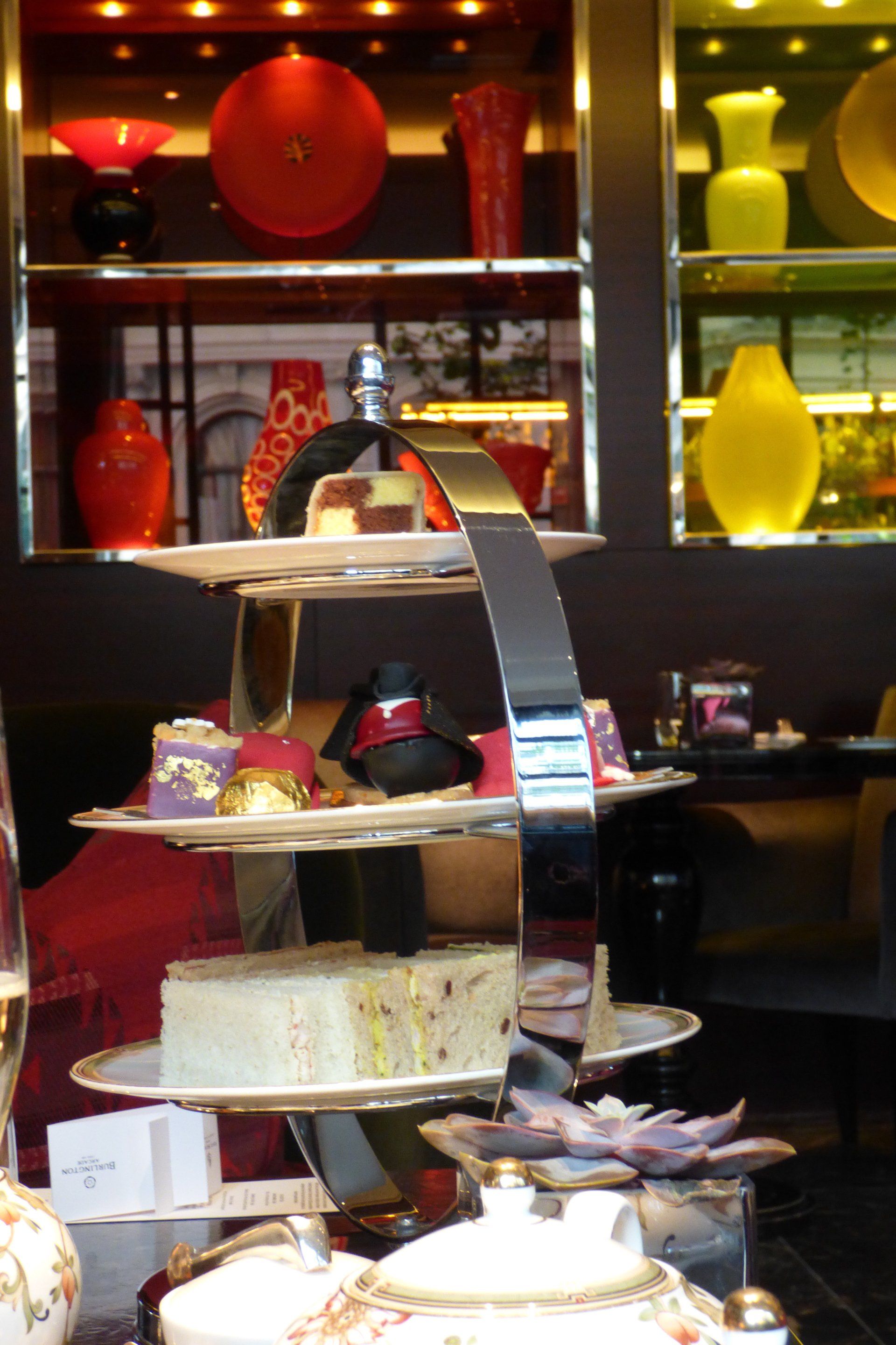 A display of desserts and vases in a room