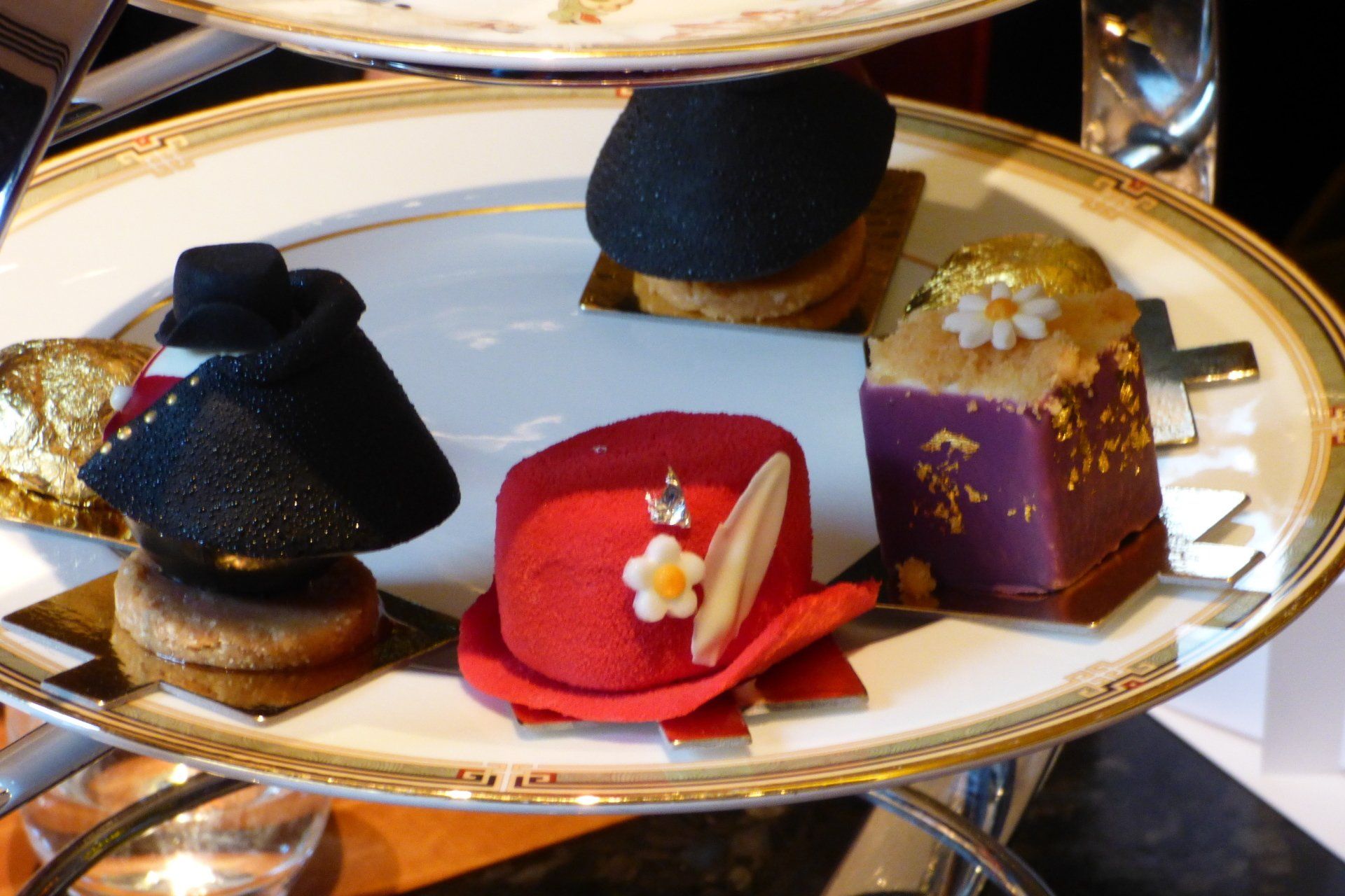 A plate of desserts with a red hat on it