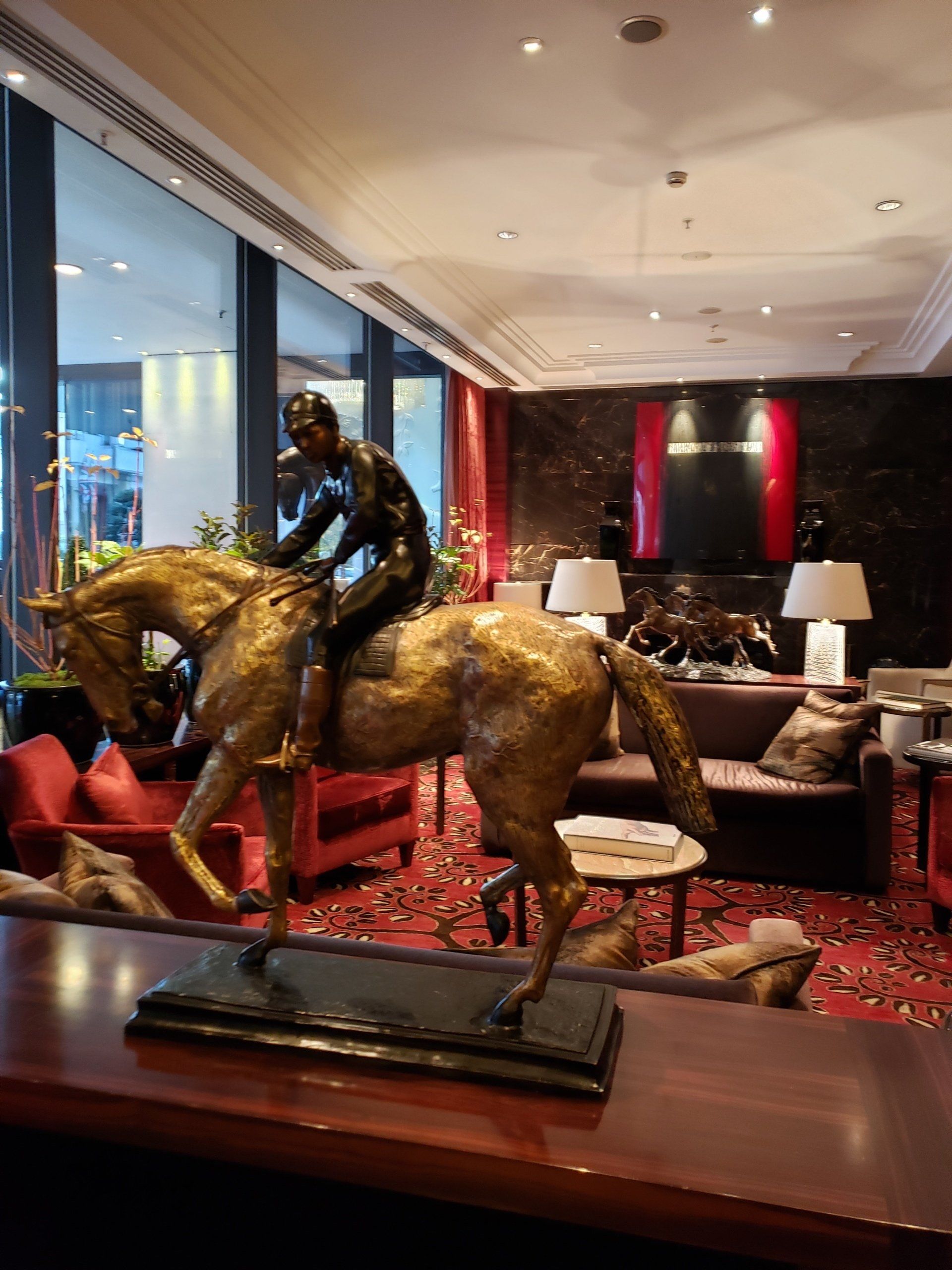 A statue of a man riding a horse in a living room