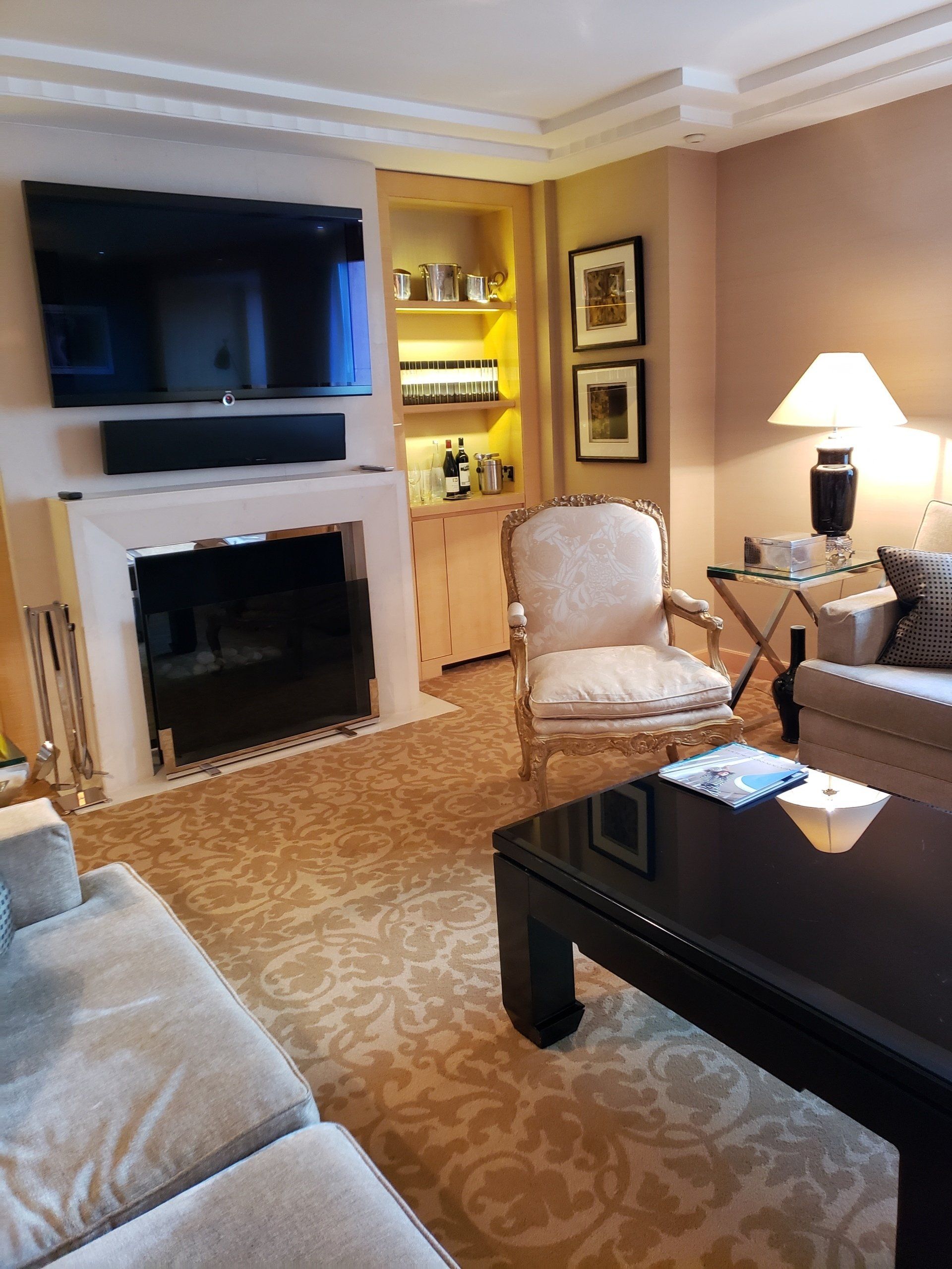 A living room with a fireplace and a flat screen tv