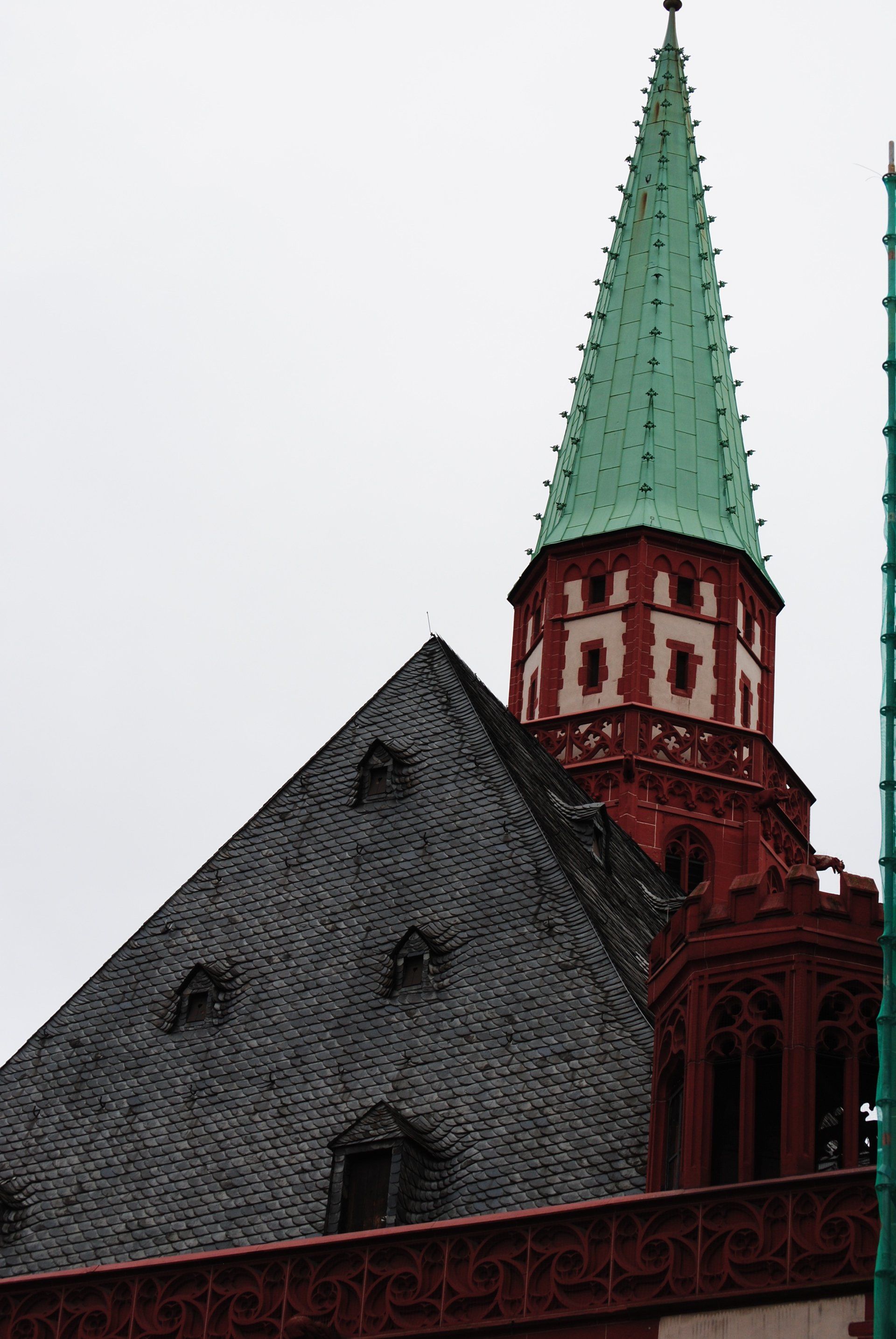 A church with a green steeple and a red tower