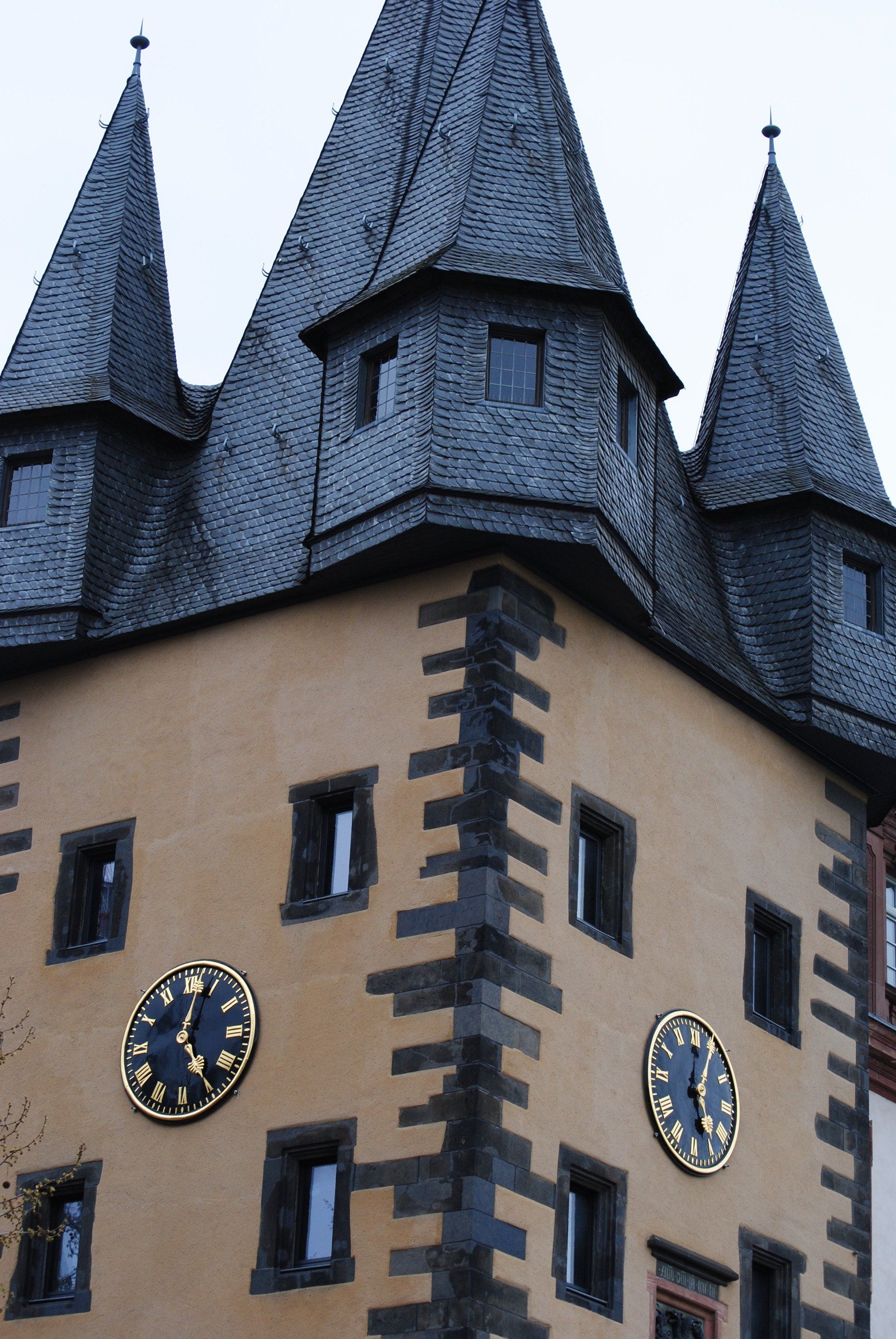 A building with three clocks on the side of it