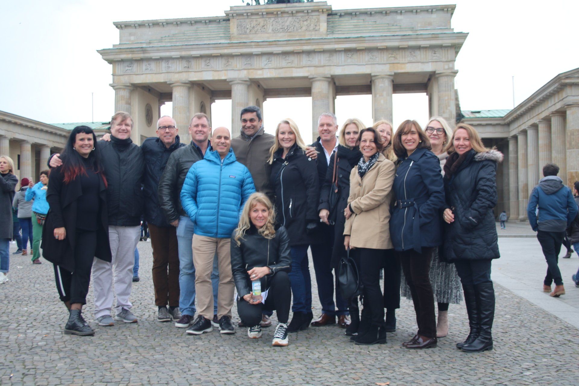 A group of people are posing for a picture in front of a building.