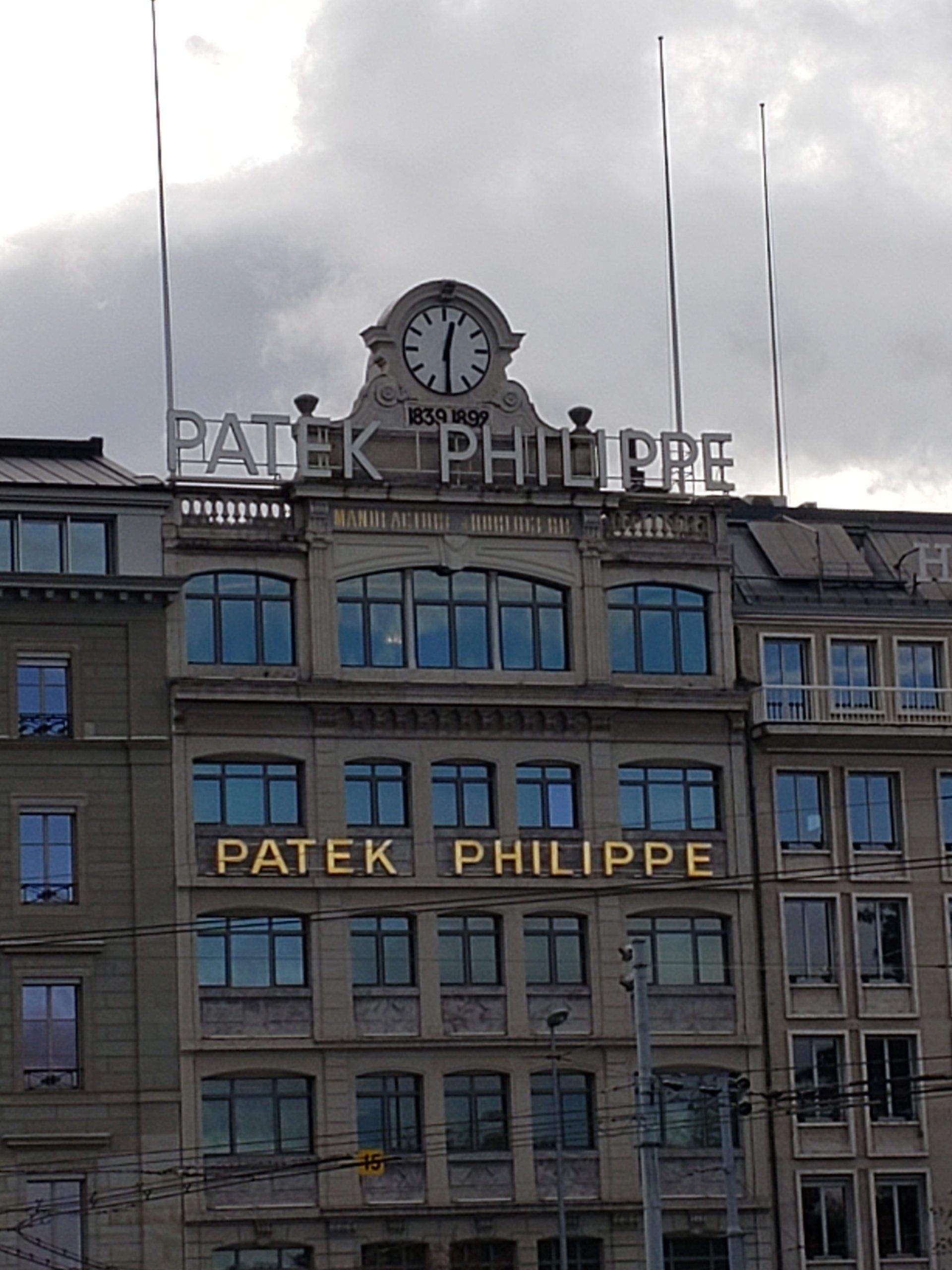 A patek philippe building with a clock on top