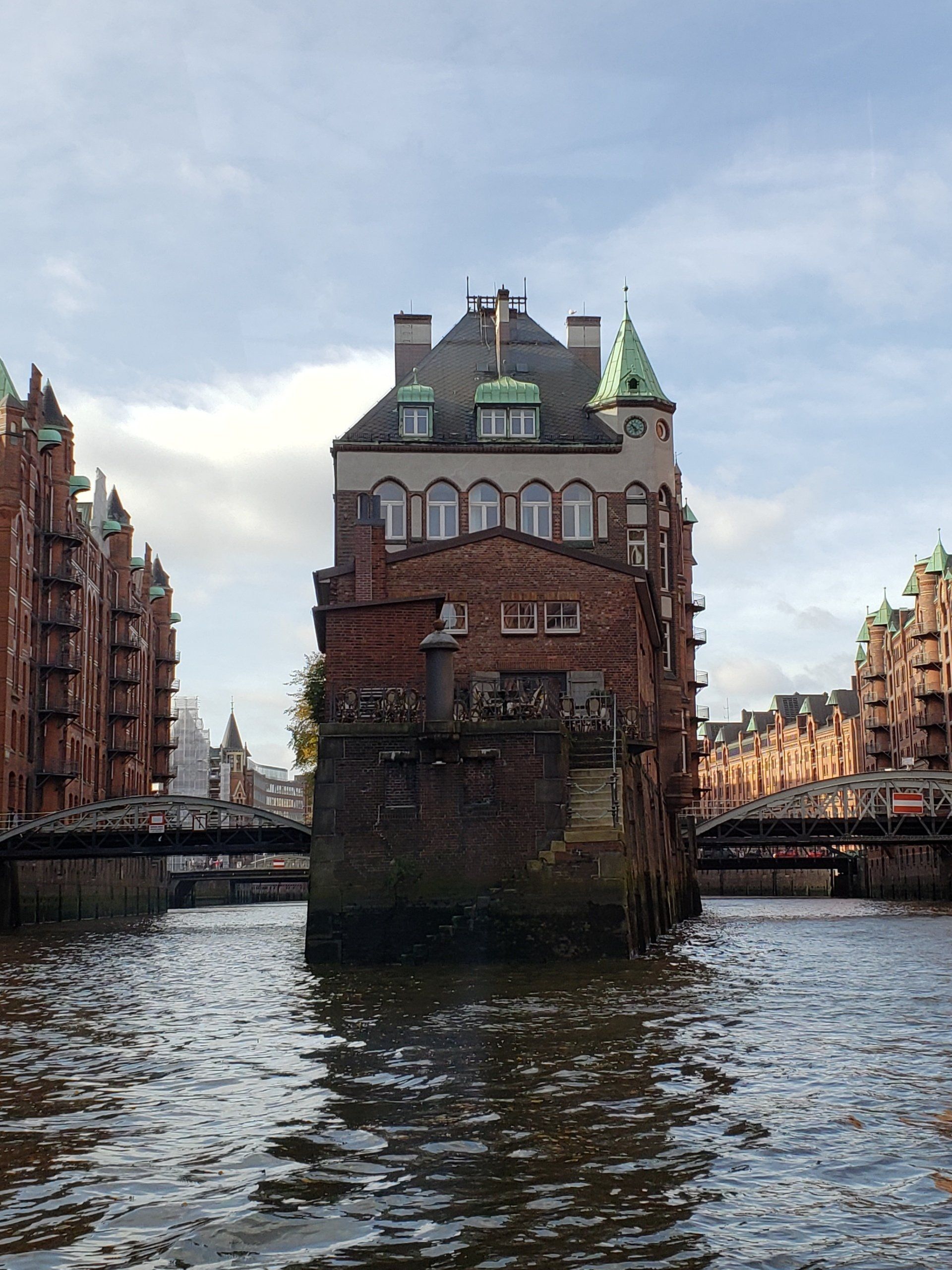 A large building is in the middle of a body of water
