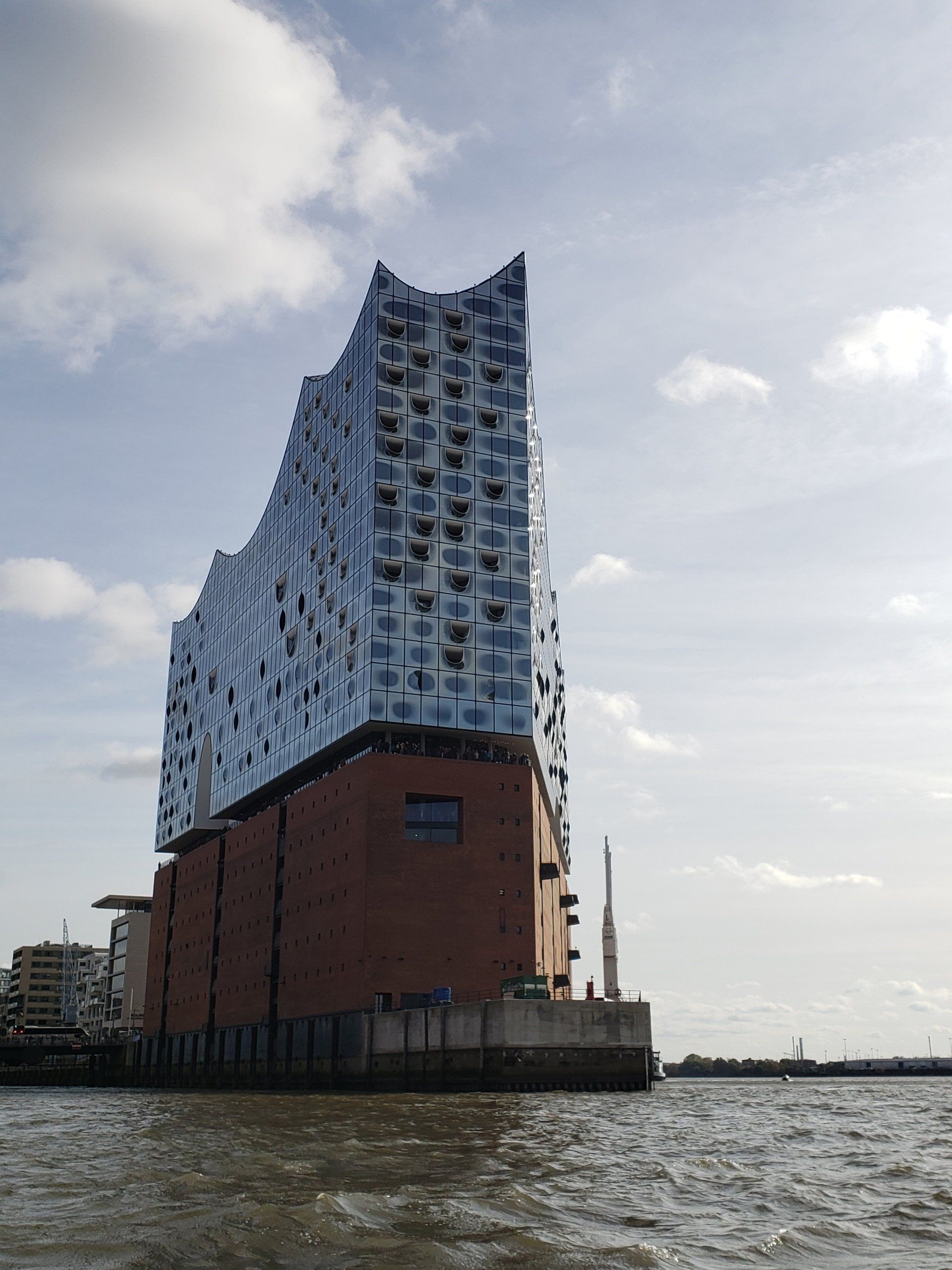 A large building is sitting on top of a body of water