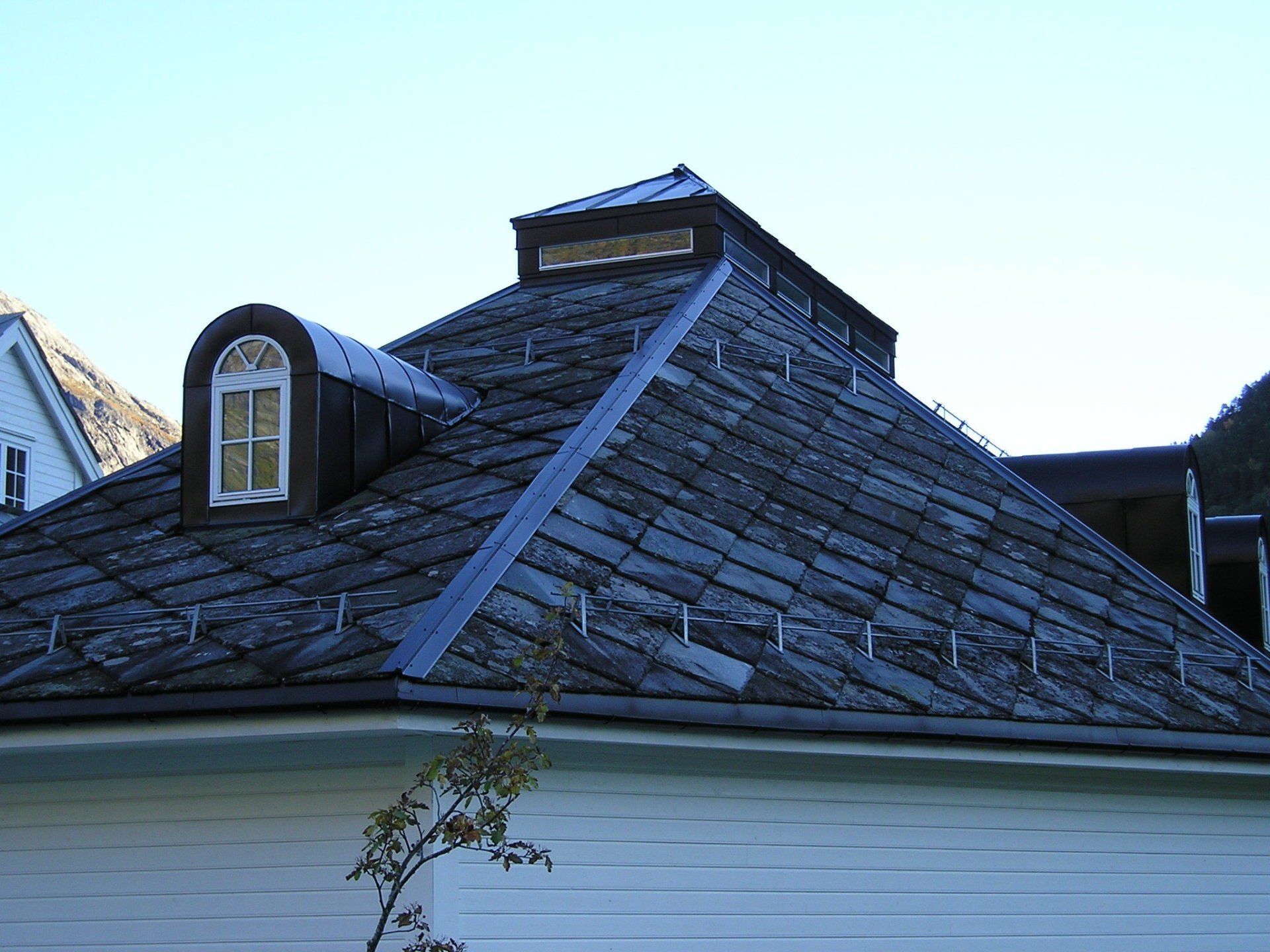 A house with a roof that has a window on it