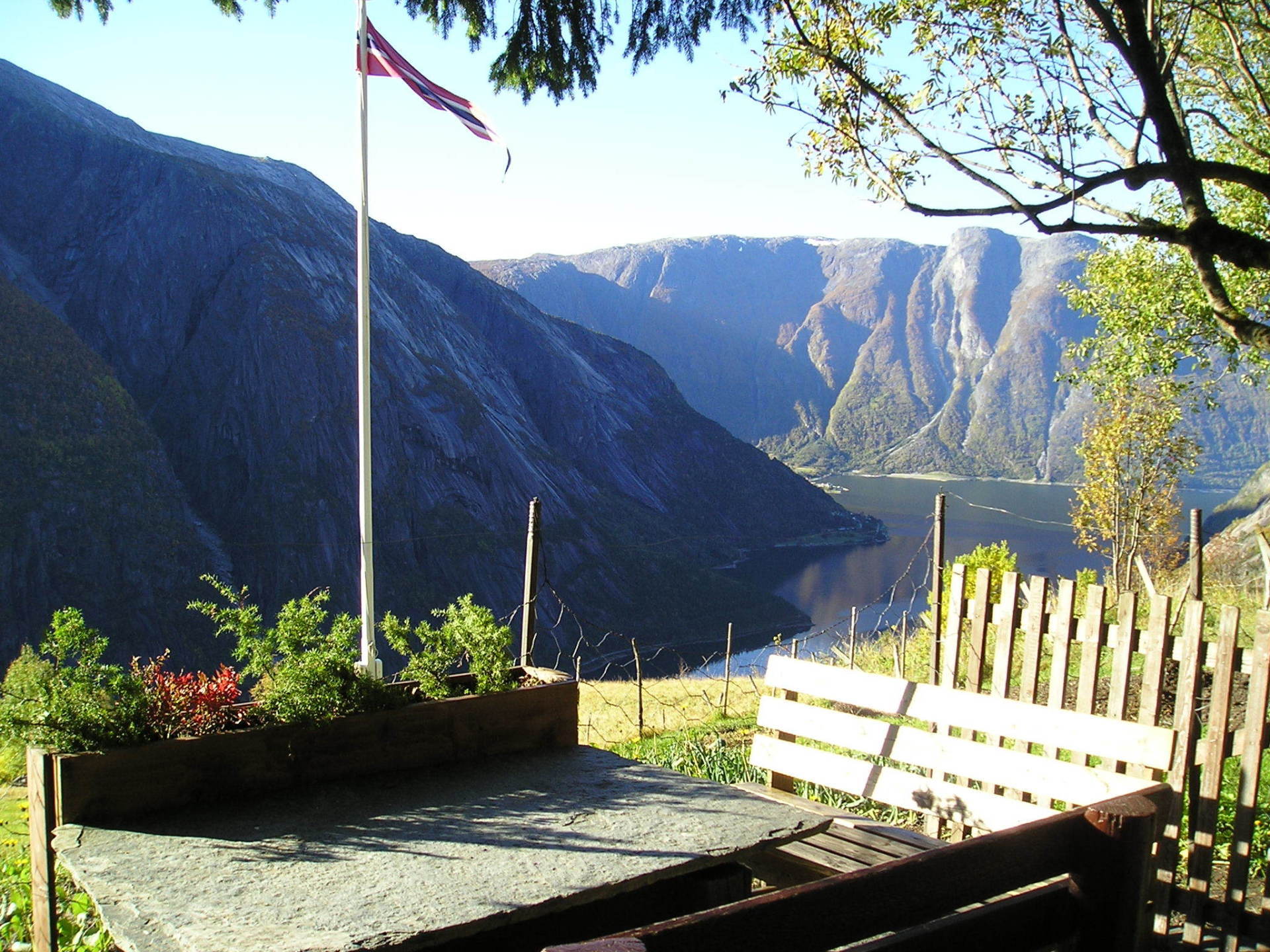 A view of a lake and mountains with a flag in the foreground
