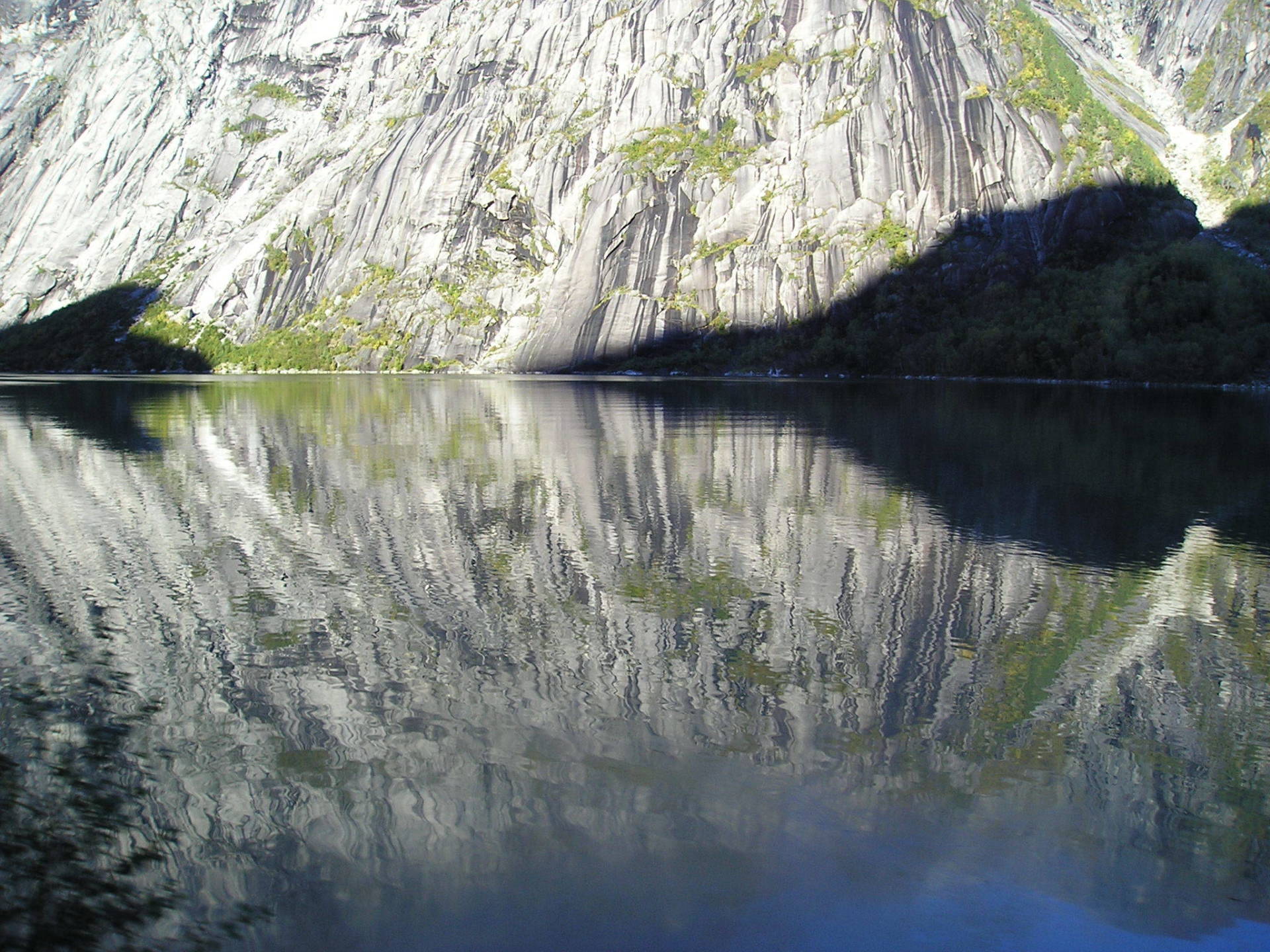 A lake with a mountain reflection in it