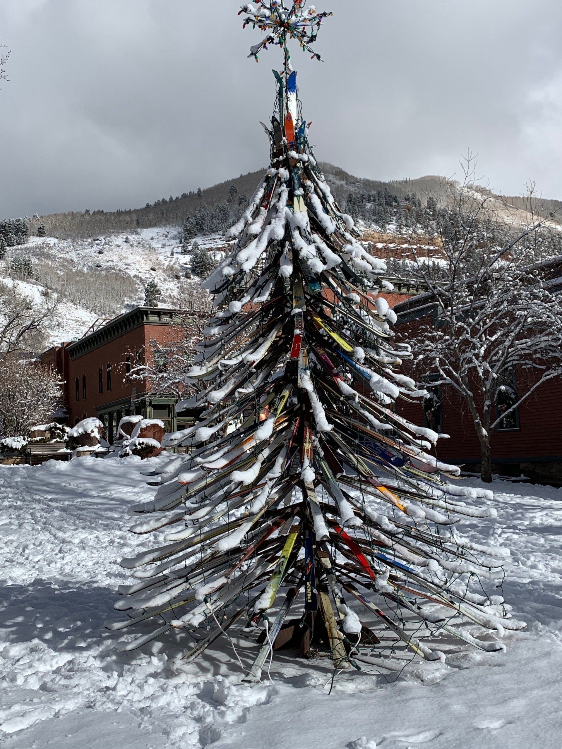 A christmas tree made out of skis in the snow