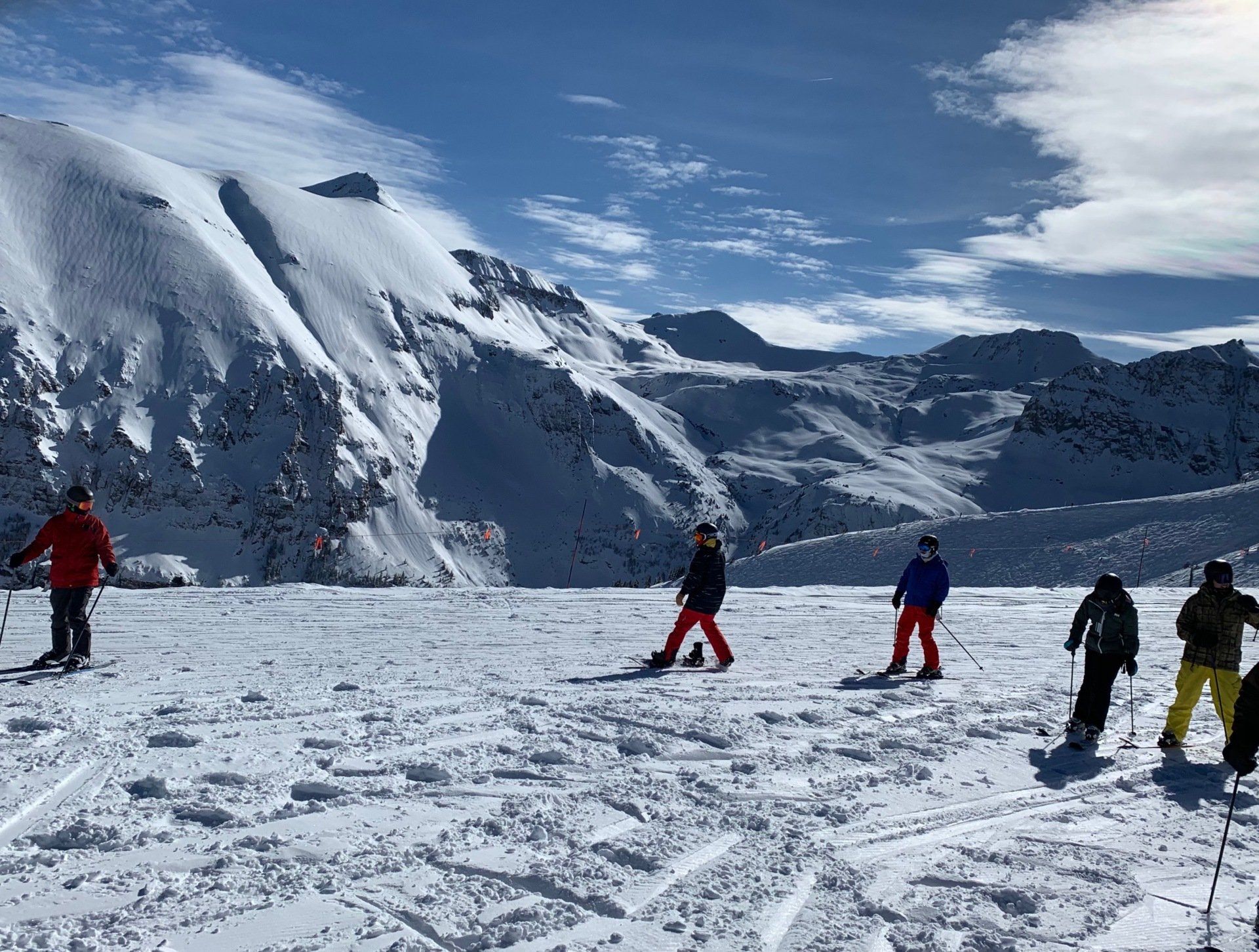 A group of people are skiing down a snow covered slope.