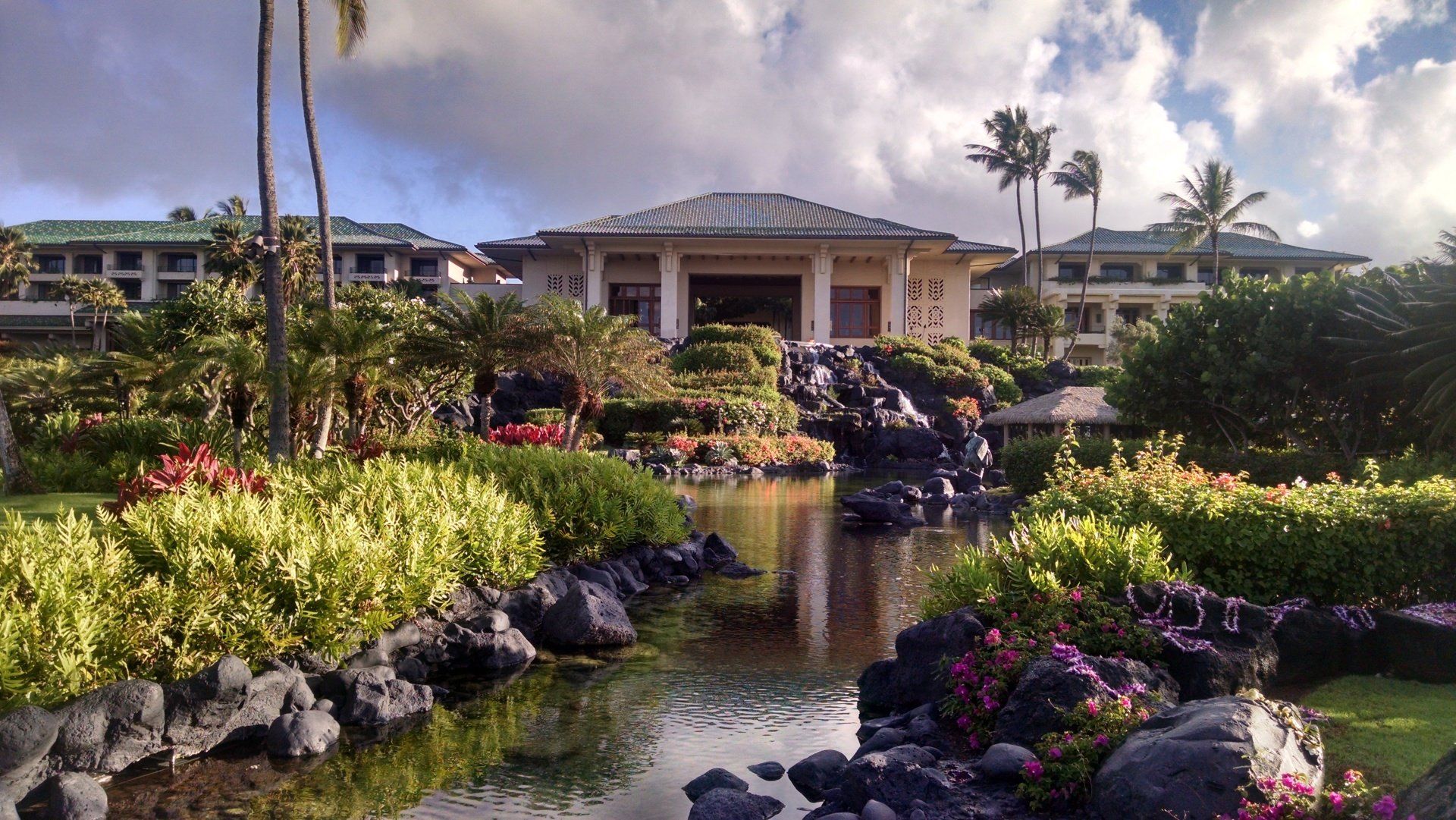 A large building with a waterfall in front of it