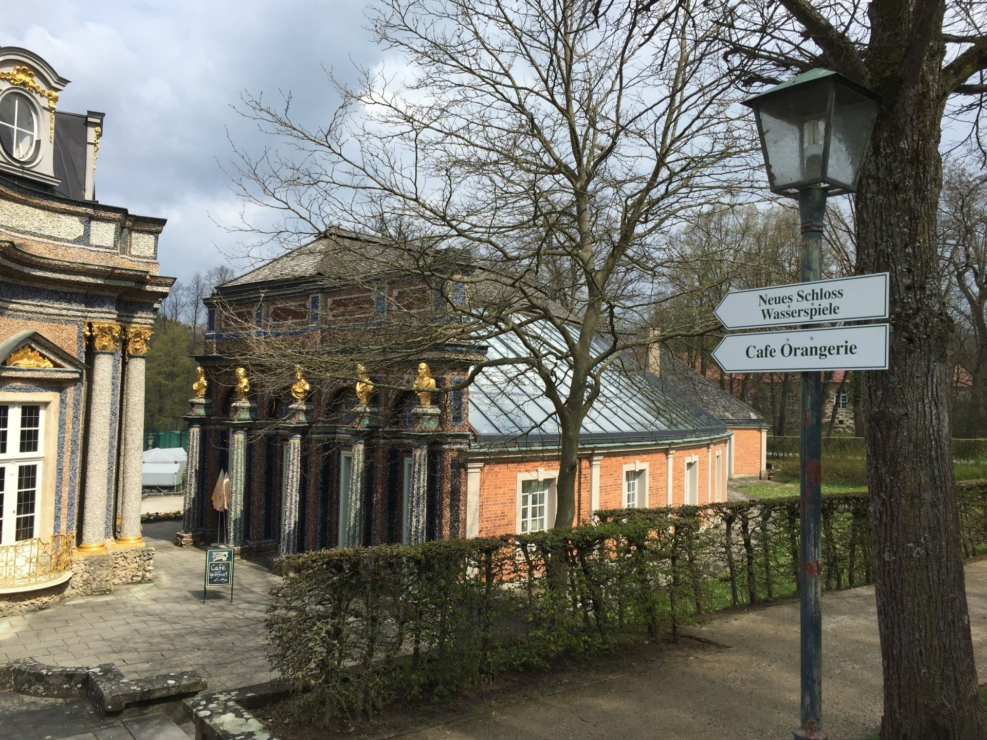 A sign on a pole points the way to a building.