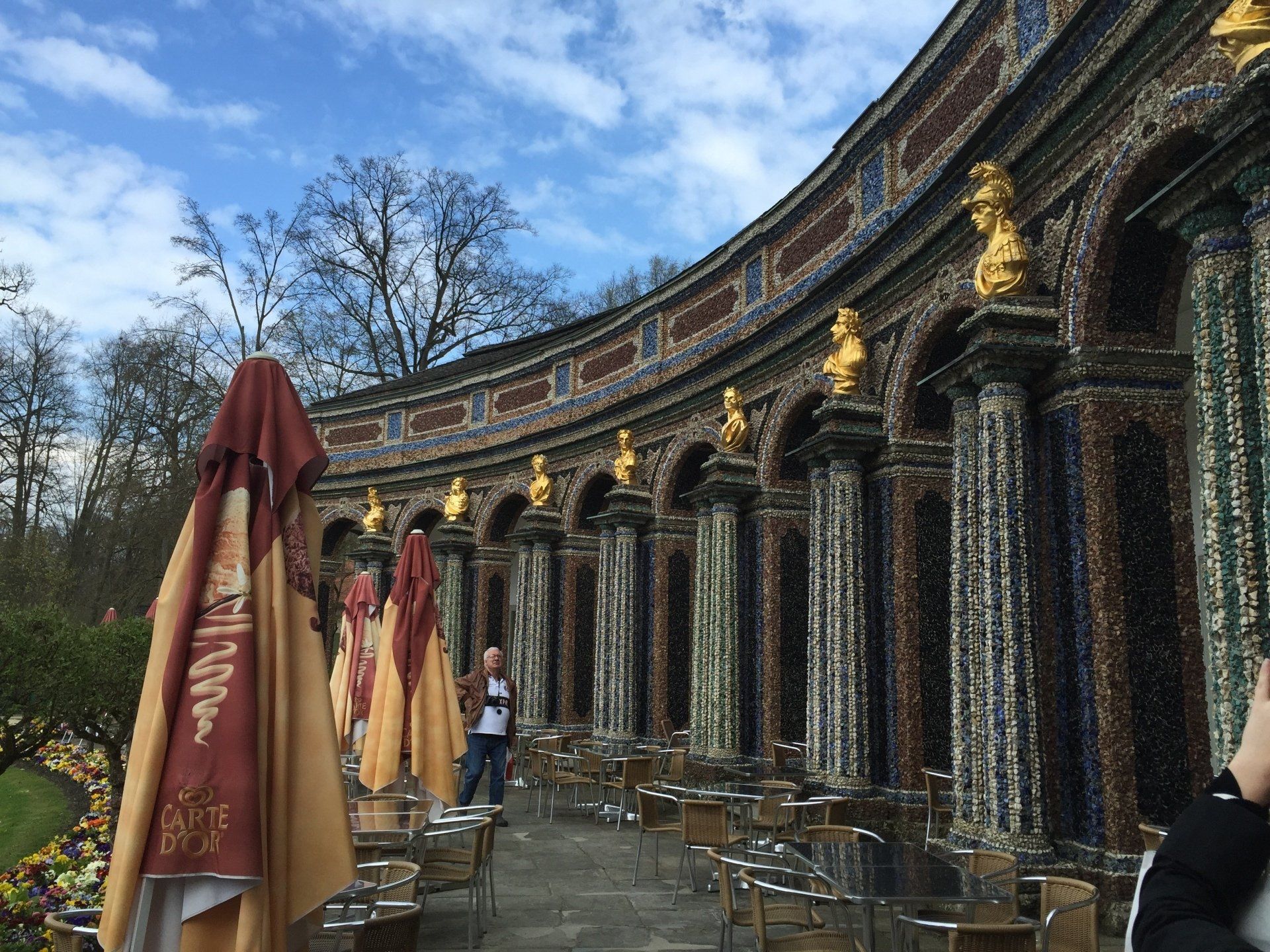 A row of umbrellas are lined up in front of a building