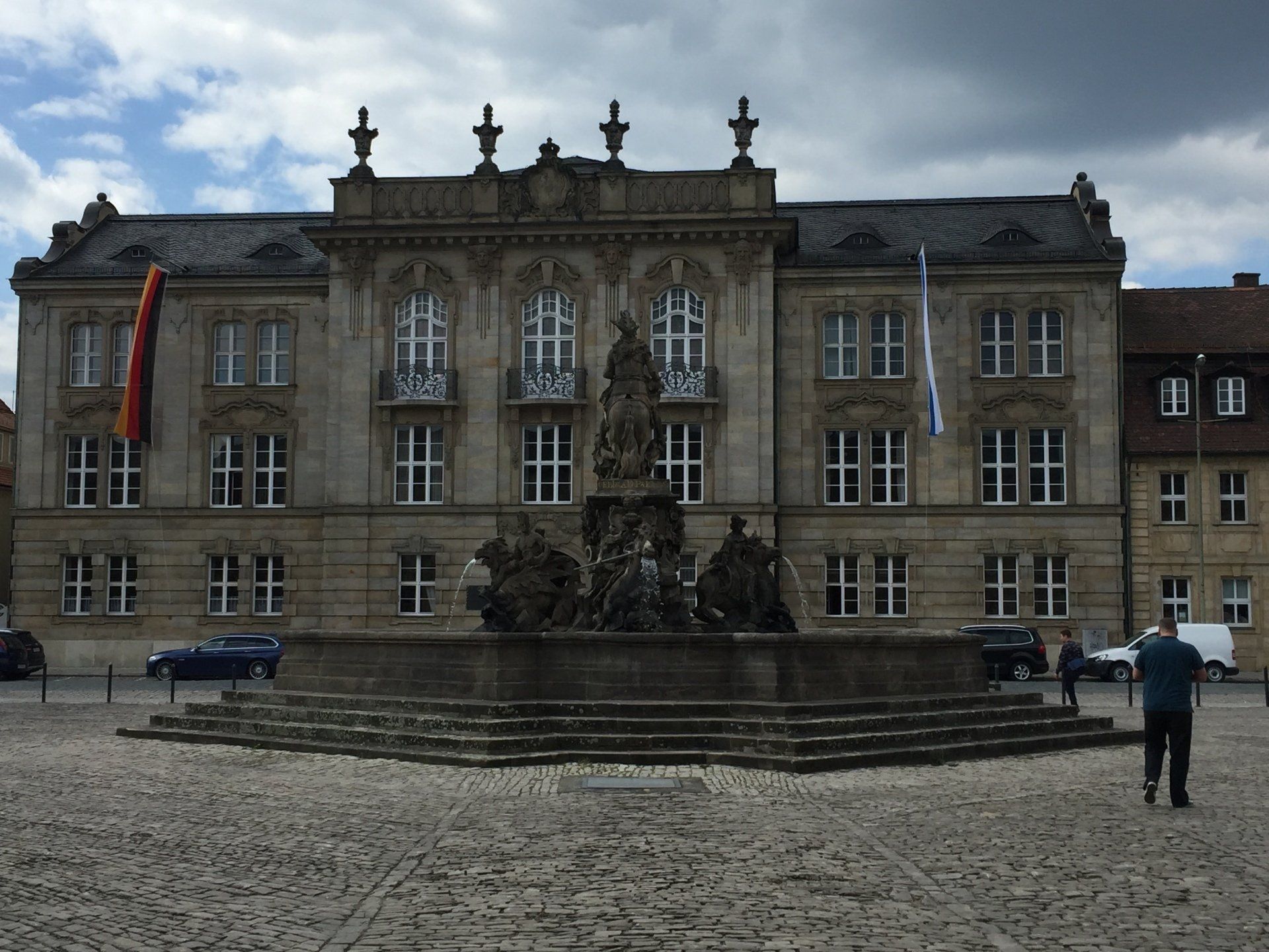 A large building with a fountain in front of it