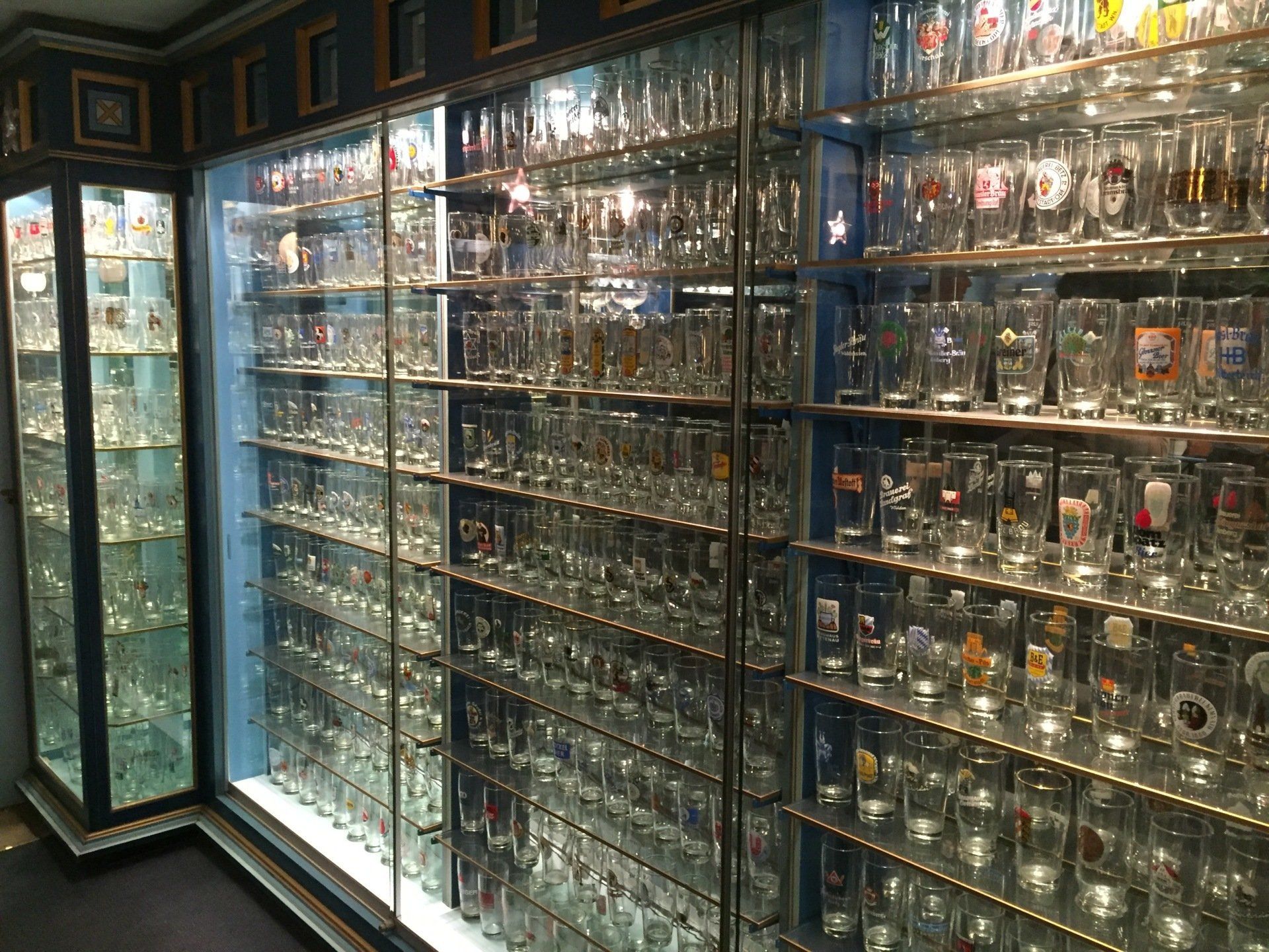 A display case filled with lots of beer glasses