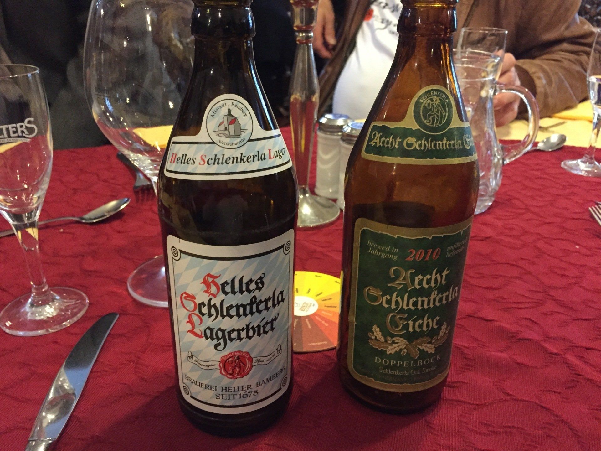 Two bottles of beer are sitting on a table