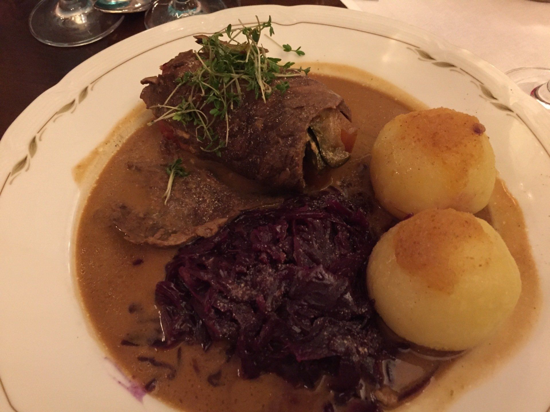 A close up of a plate of food with meat and potatoes