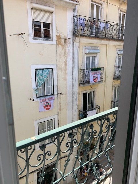 A view of a building from a balcony with a sign that says ' i love you ' on it