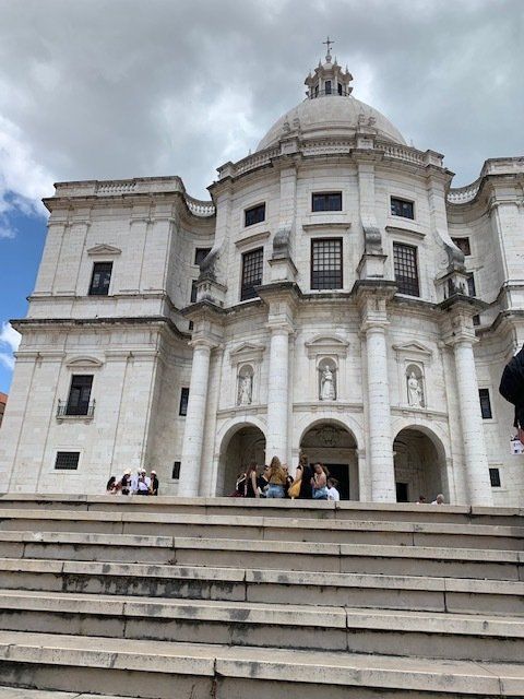 A large white building with a dome on top of it