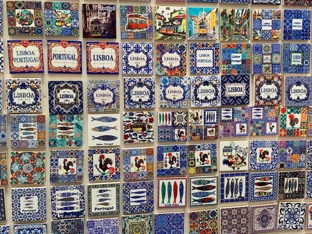 A wall full of colorful tiles with the word lisboa on them