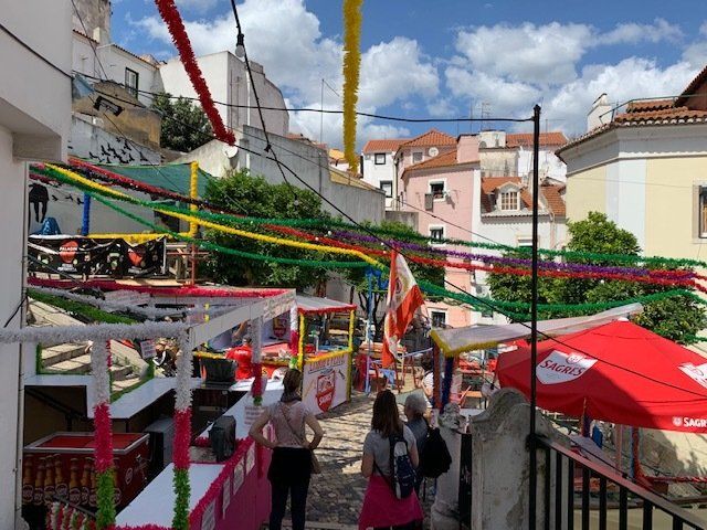 A group of people are walking down a narrow street.
