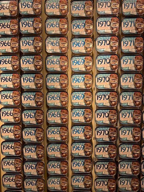 There are many cans of sardines from different years.