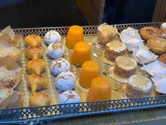 A silver tray filled with a variety of desserts