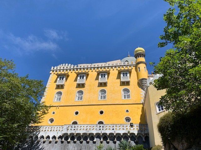 A yellow building with a blue sky in the background