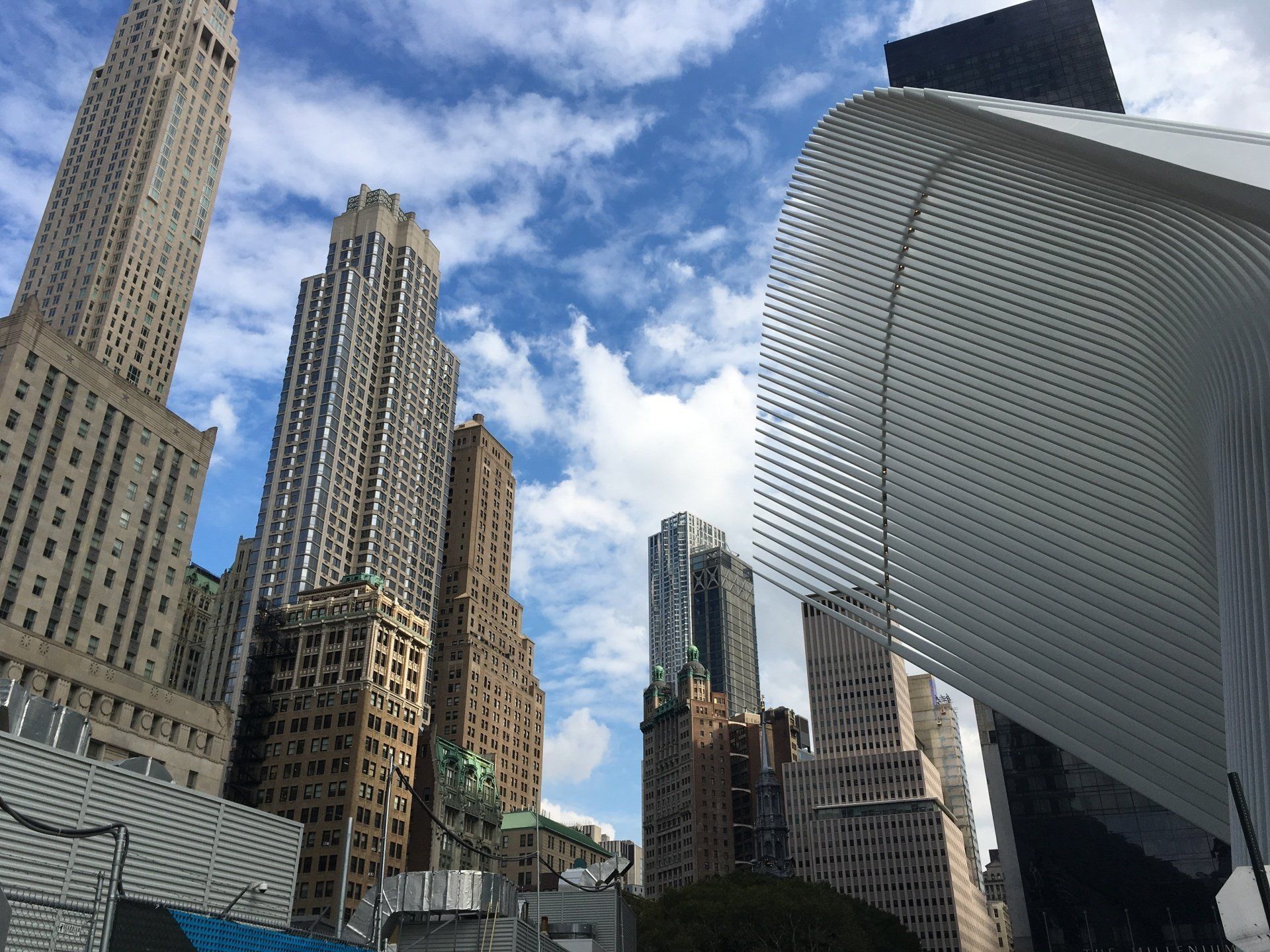 A city with a lot of tall buildings and a blue sky