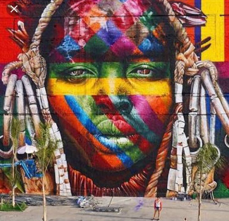 A colorful painting of a woman 's face on a wall