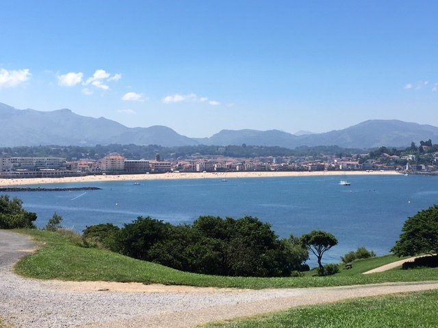 A view of a body of water with mountains in the background