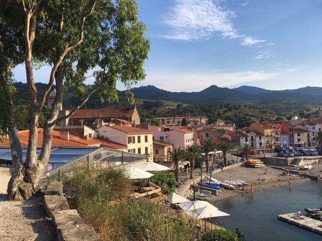 A view of a small town with mountains in the background