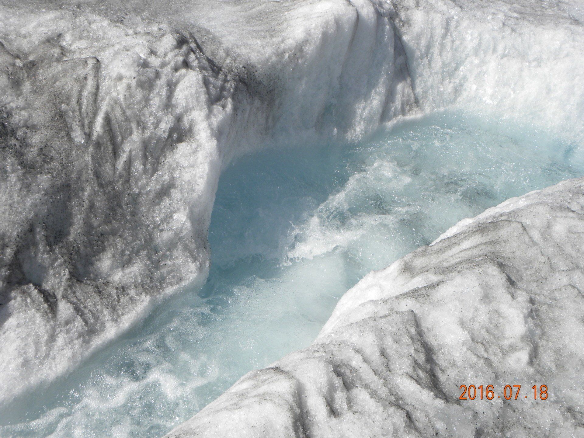 A large body of water is surrounded by ice and snow.